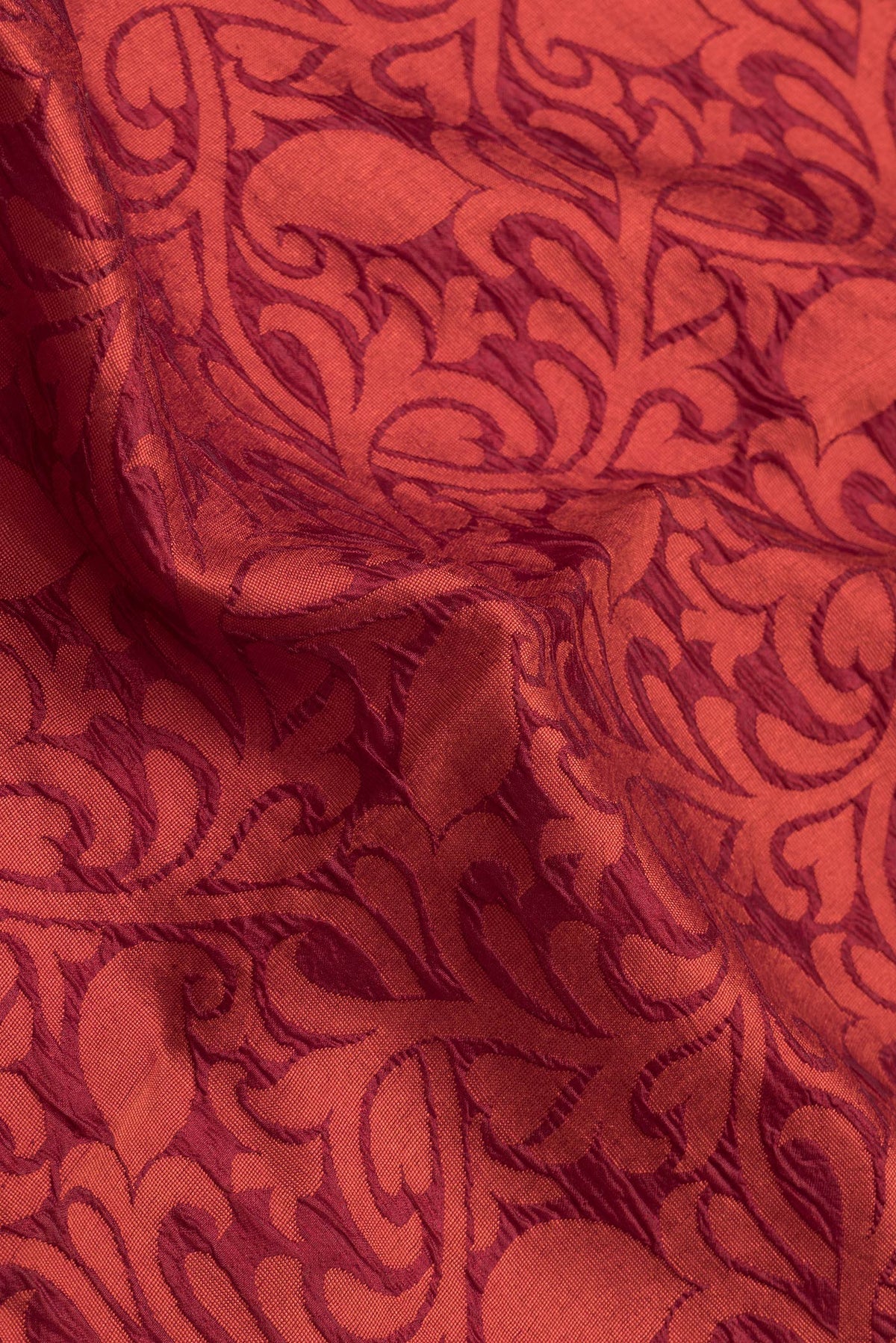 Close up of Maroon Dual Tone Tussar Silk Saree with Jacquard design on the body and Zari Border.  displaying folds
