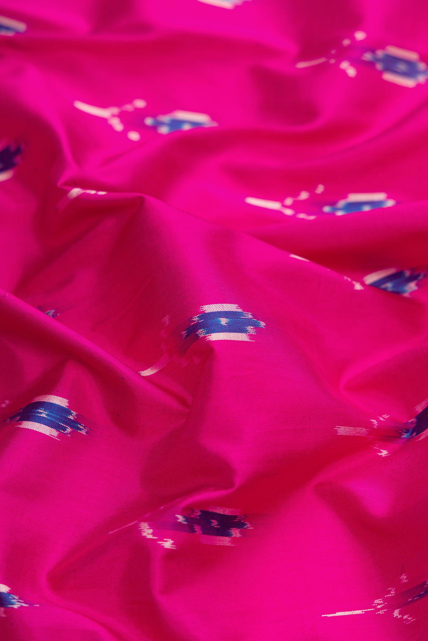 Close up of Pink Dual Tone Double Ikat Saree with Ikat Print on the body and Ikat Border.  displaying folds