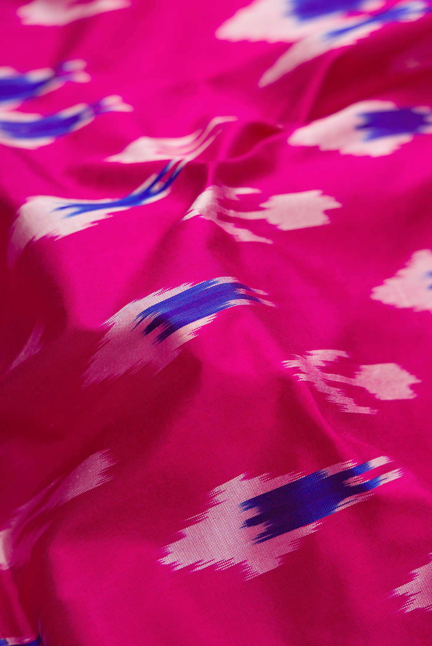 Close up of Pink Dual Tone Double Ikat Saree with Ikat Print on the body and Ikat Border.  displaying folds