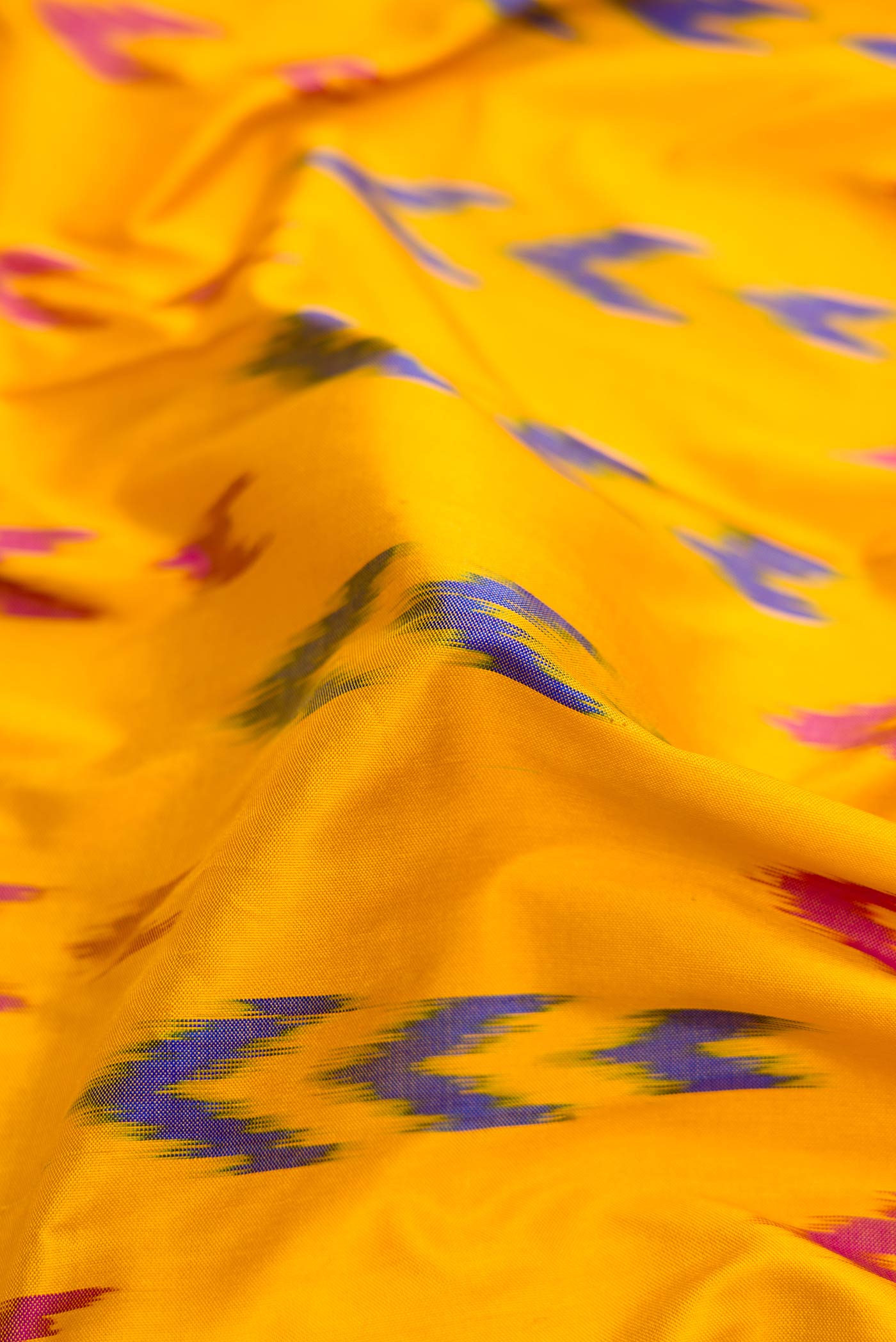 Close up of Yellow Pochampally Silk Saree with Pure Ikat on the body and Zari Border displaying folds