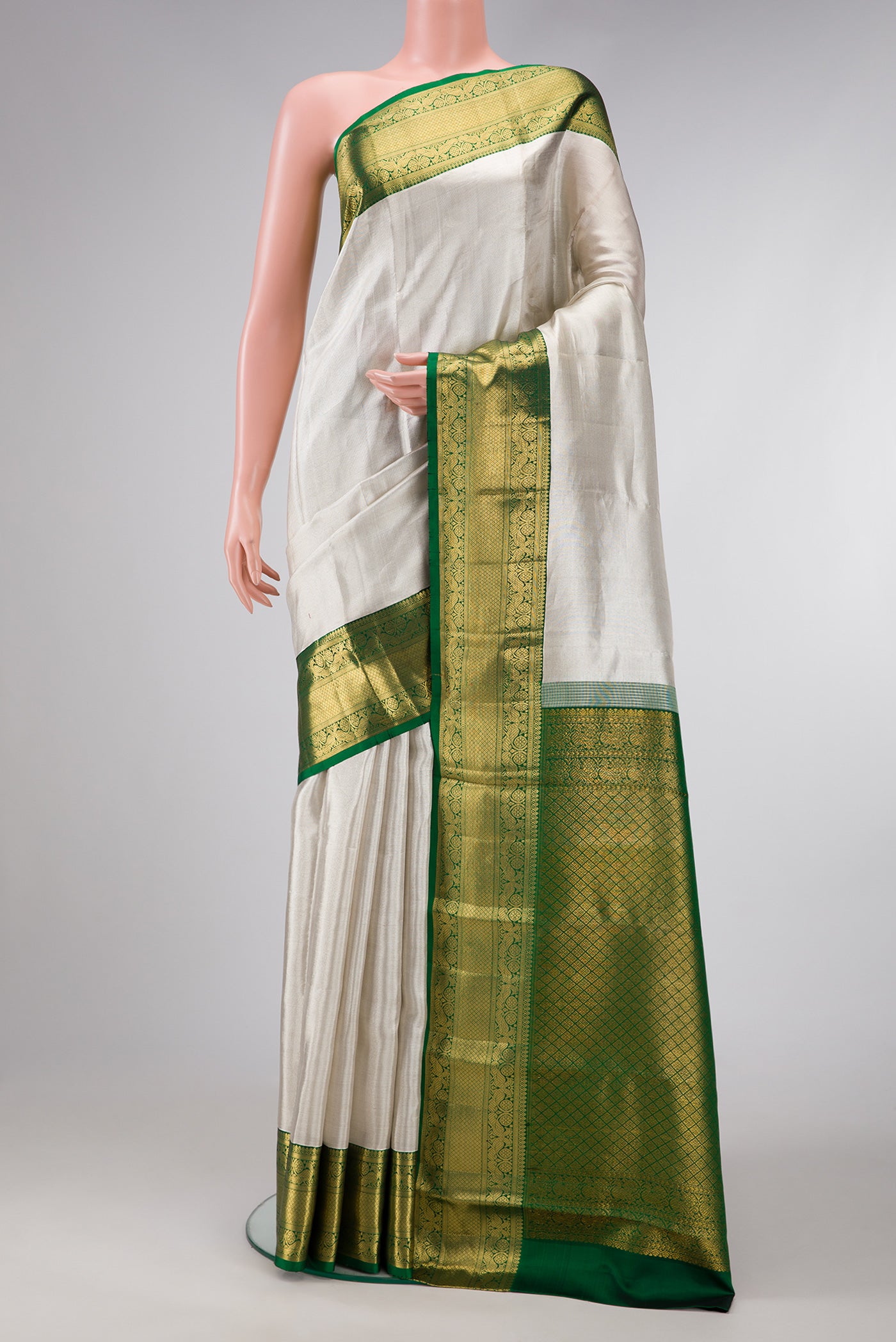 Off White Dual Tone Kanchipuram Tissue Silk Saree with Plain Body and Zari Border.  displayed on a mannequin