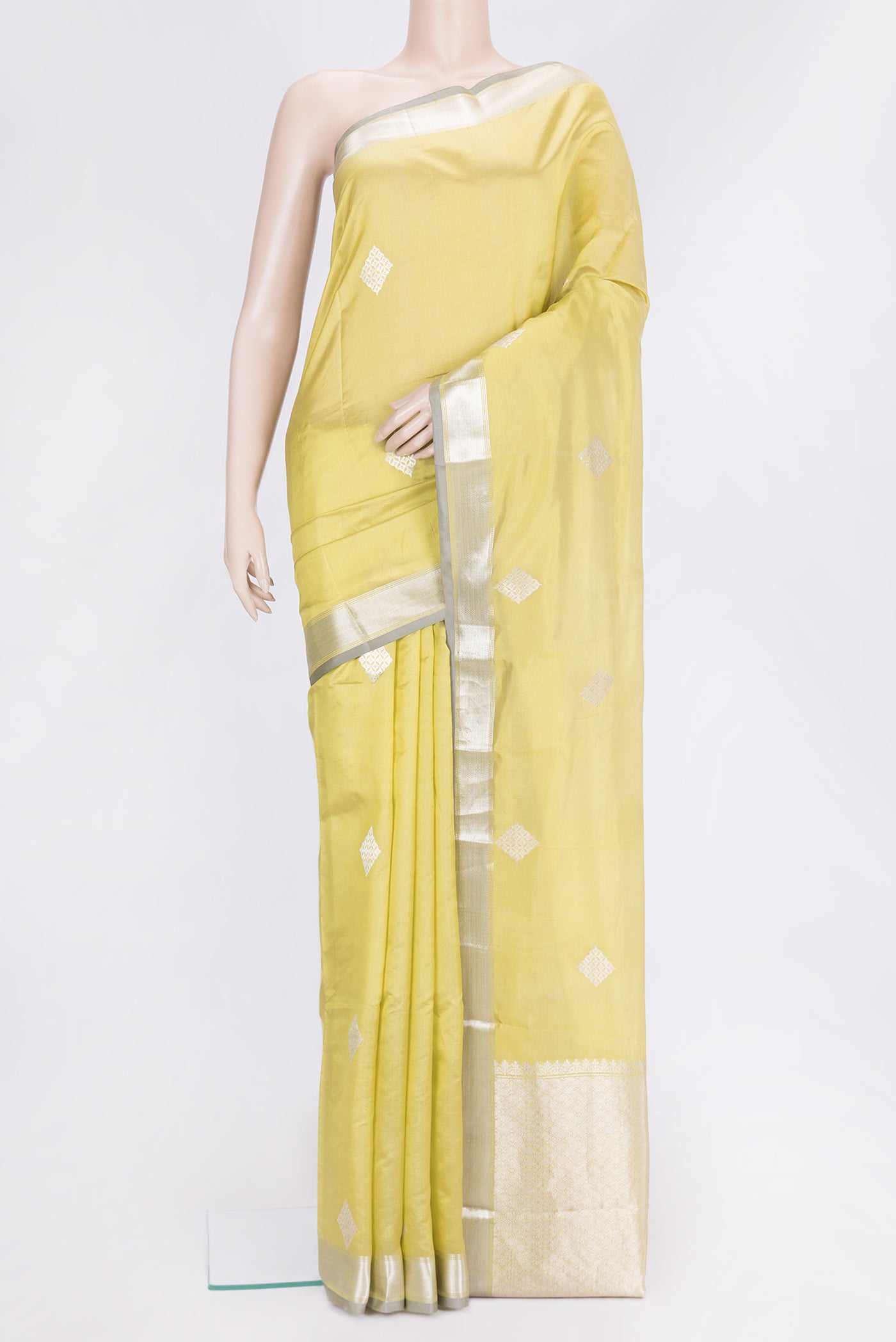 Parrot Green Dual Tone Tussar Silk Saree with Zari Butta on the body and Zari Border.  displayed on a mannequin