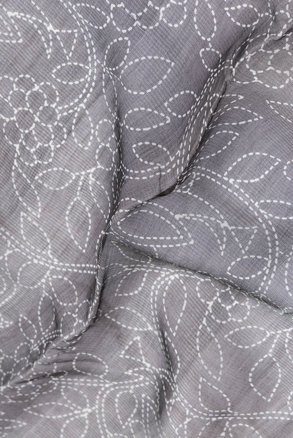 Close up of Black Dual Tone Tussar Silk Saree with Printed design on the body and Plain Border.  displaying folds