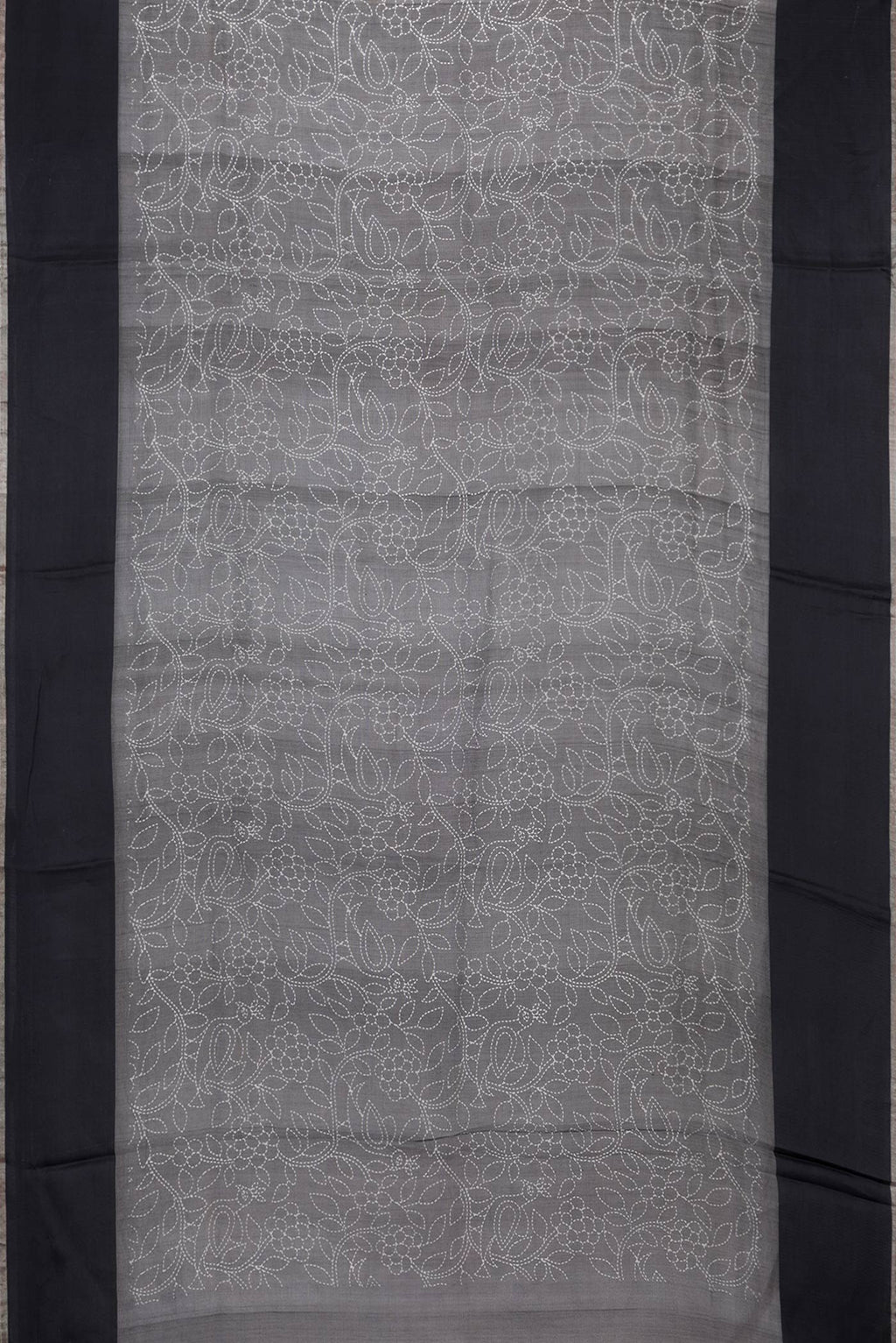 Flat view of Black Dual Tone Tussar Silk Saree with Printed design on the body and Plain Border. 