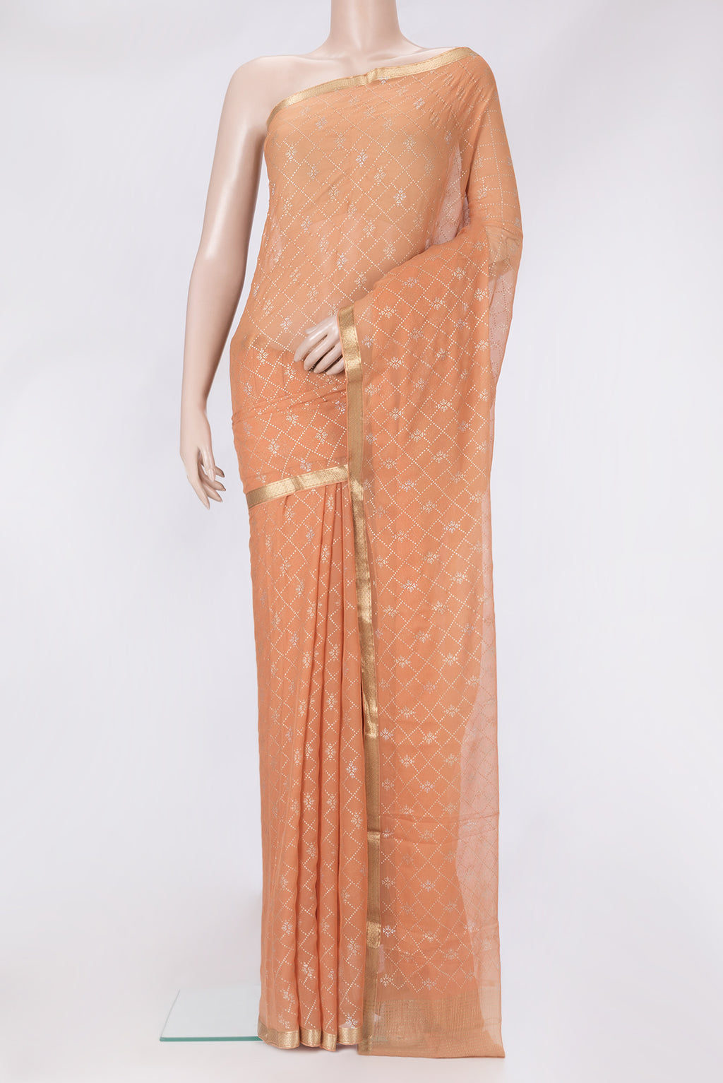 Peach Mysore Chiffon Saree with Printed design on the body and Zari Border.  displayed on a mannequin