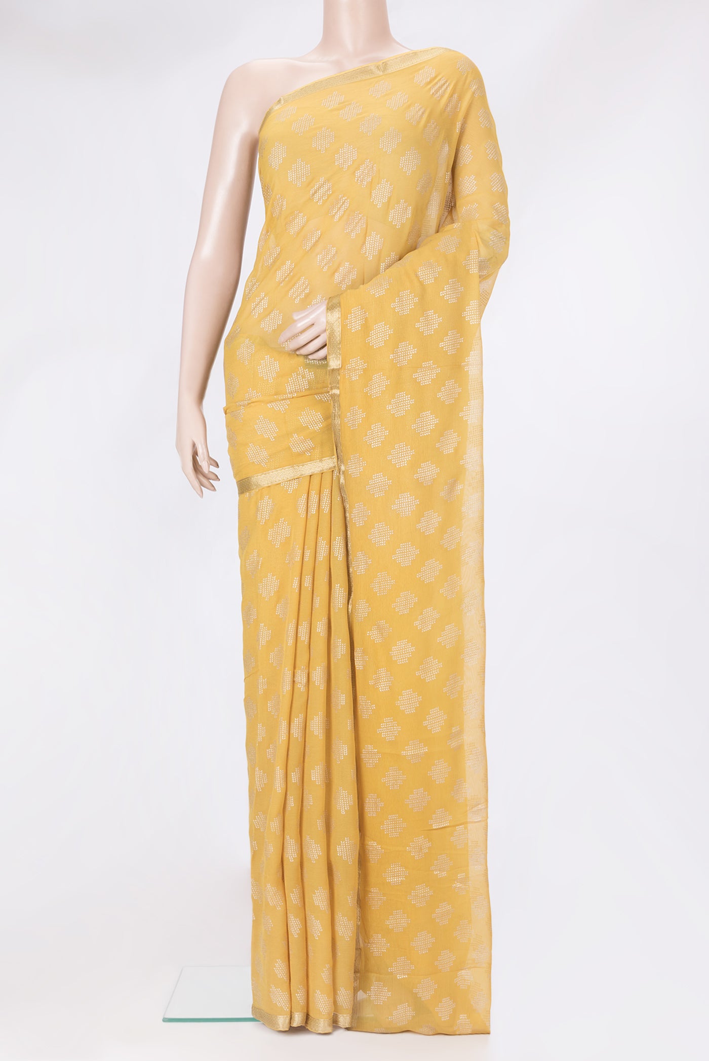Yellow Mysore Chiffon Saree with Printed design on the body and Zari Border.  displayed on a mannequin