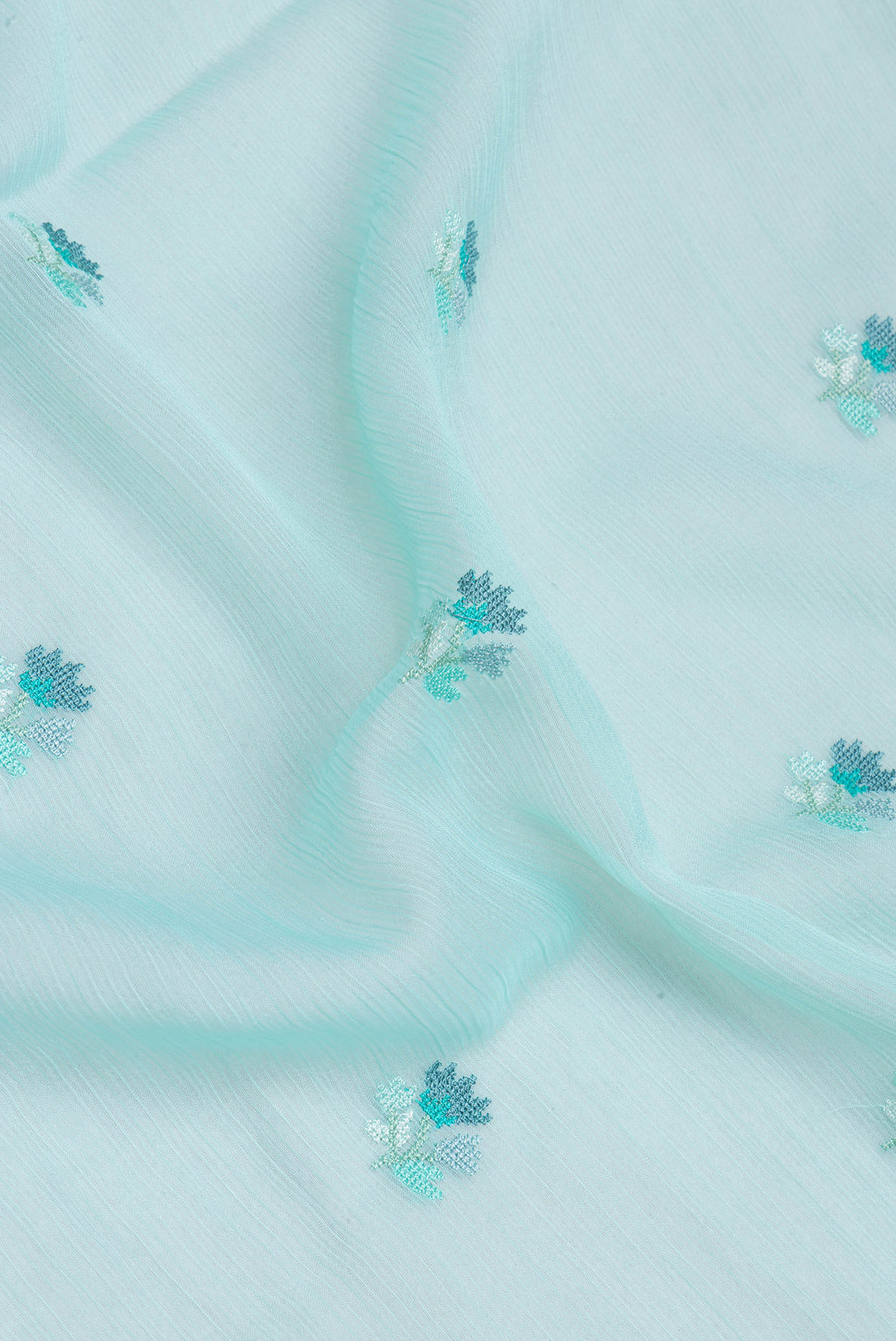 Close up of Sea Green Blended Chiffon Saree with Embroidery on the body and Embroidery Border.  displaying folds