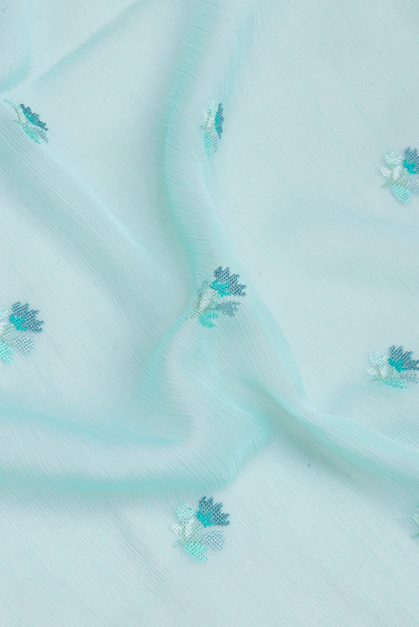 Close up of Sea Green Blended Chiffon Saree with Embroidery on the body and Embroidery Border.  displaying folds