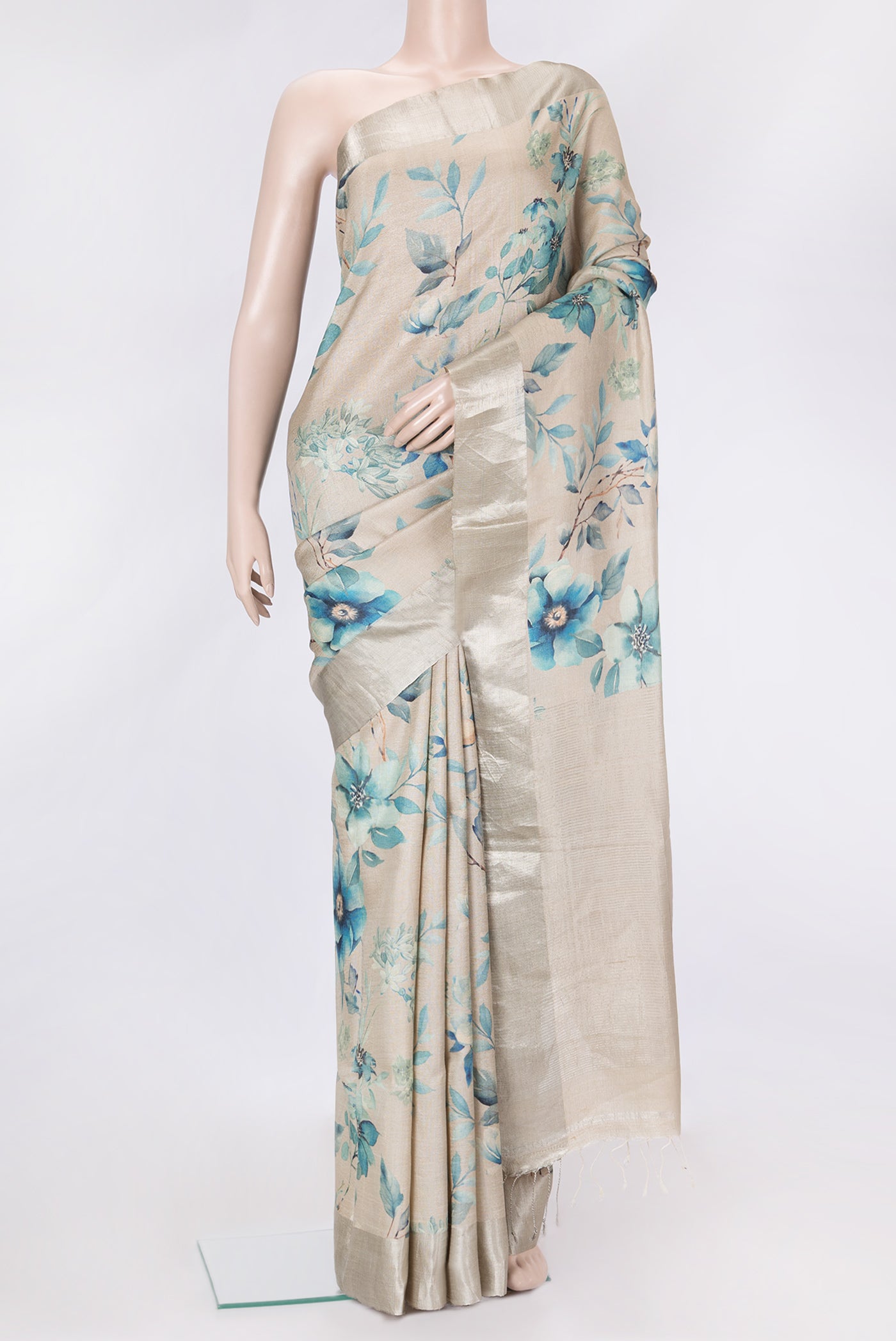 Beige Dual Tone Tussar Silk Saree with Printed design on the body and Zari Border.  displayed on a mannequin