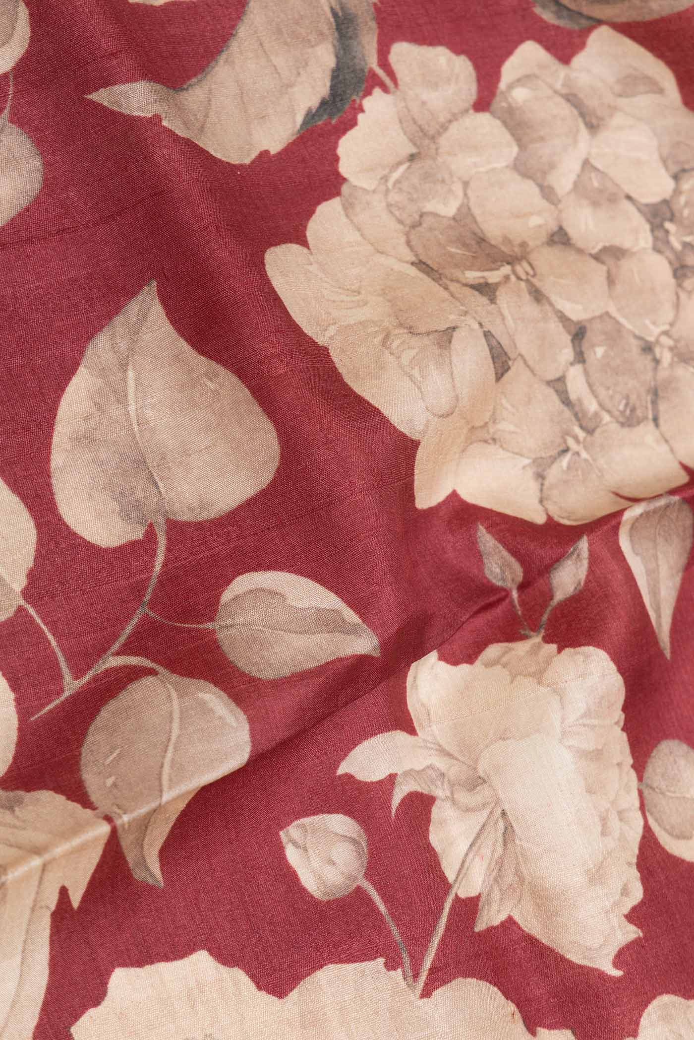 Close up of Maroon Dual Tone Tussar Silk SareePrinted design on the body and Zari Border displaying folds