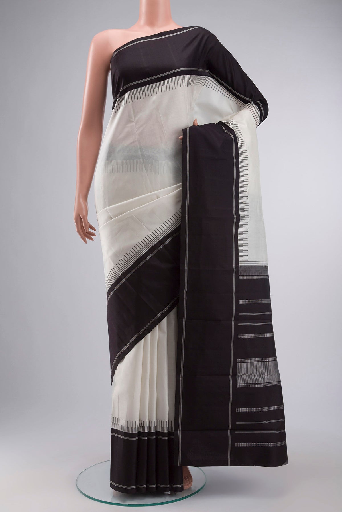 White Kanchipuram Silk Saree with Plain Body and Plain Border displayed on a mannequin