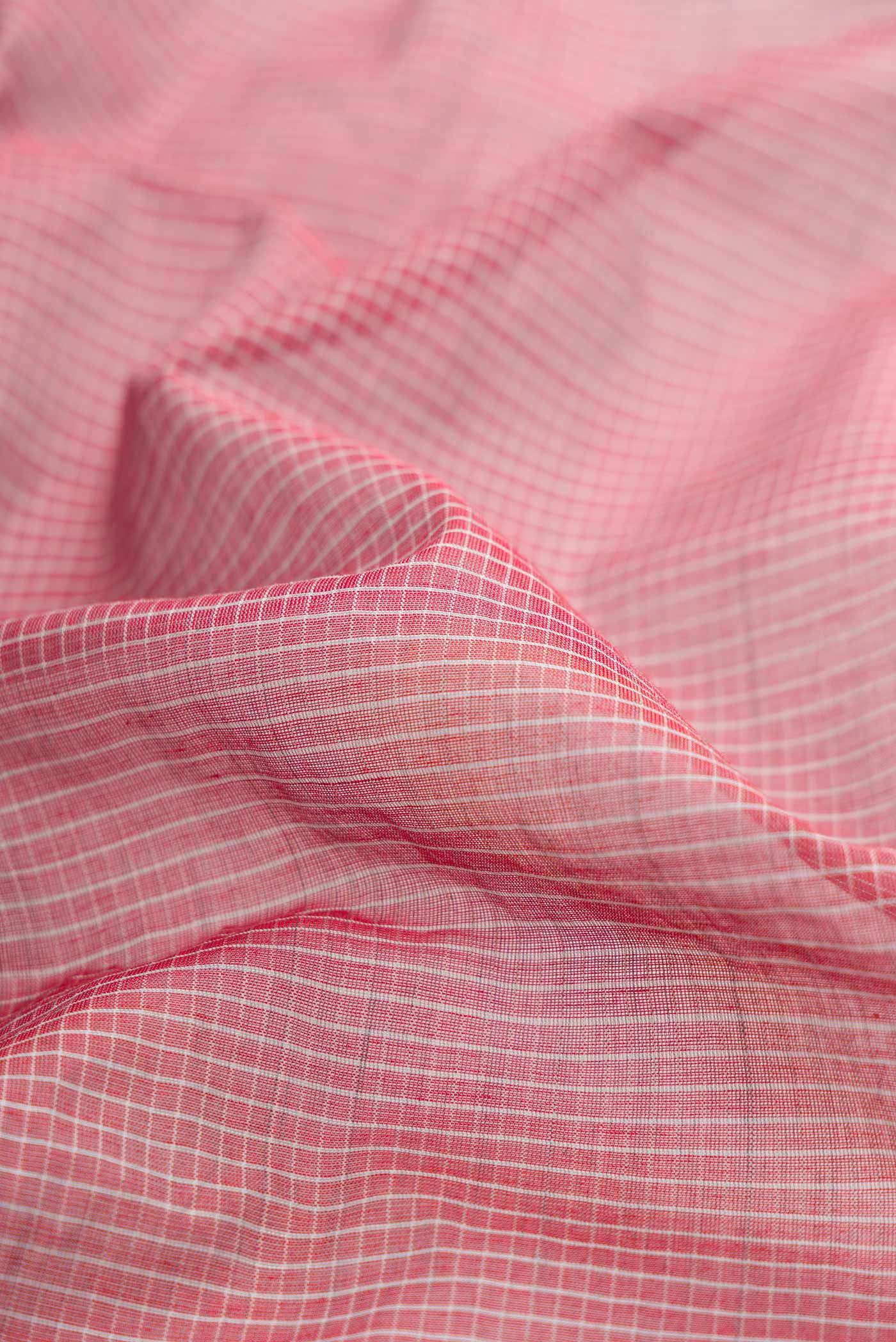 Close up of Red Gadwal cotton Saree with Checked design on the body and Silk Border displaying folds