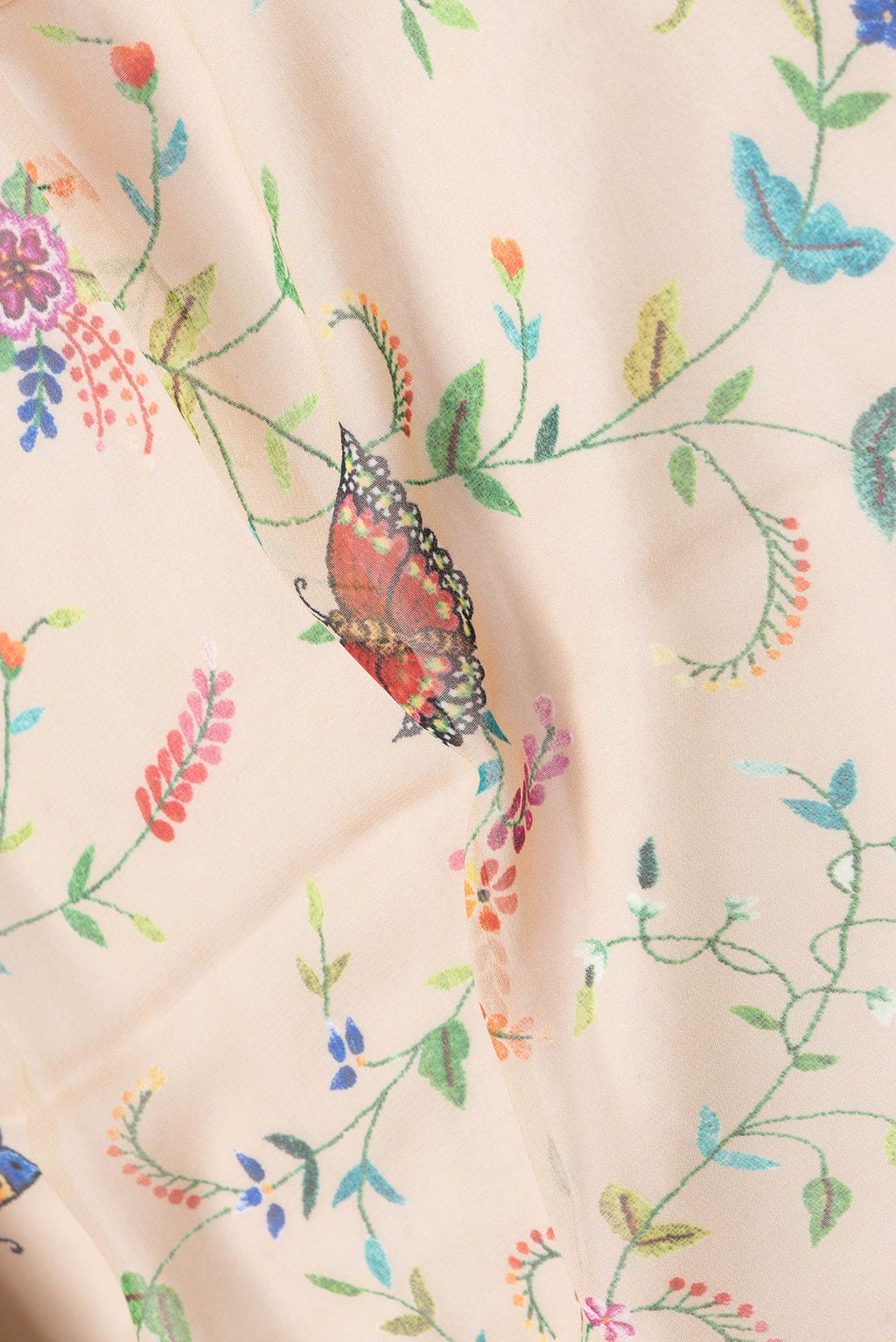 Close up of Beige Dual Tone Mysore Georgette Saree with Printed design on the body and Without Border.  displaying folds