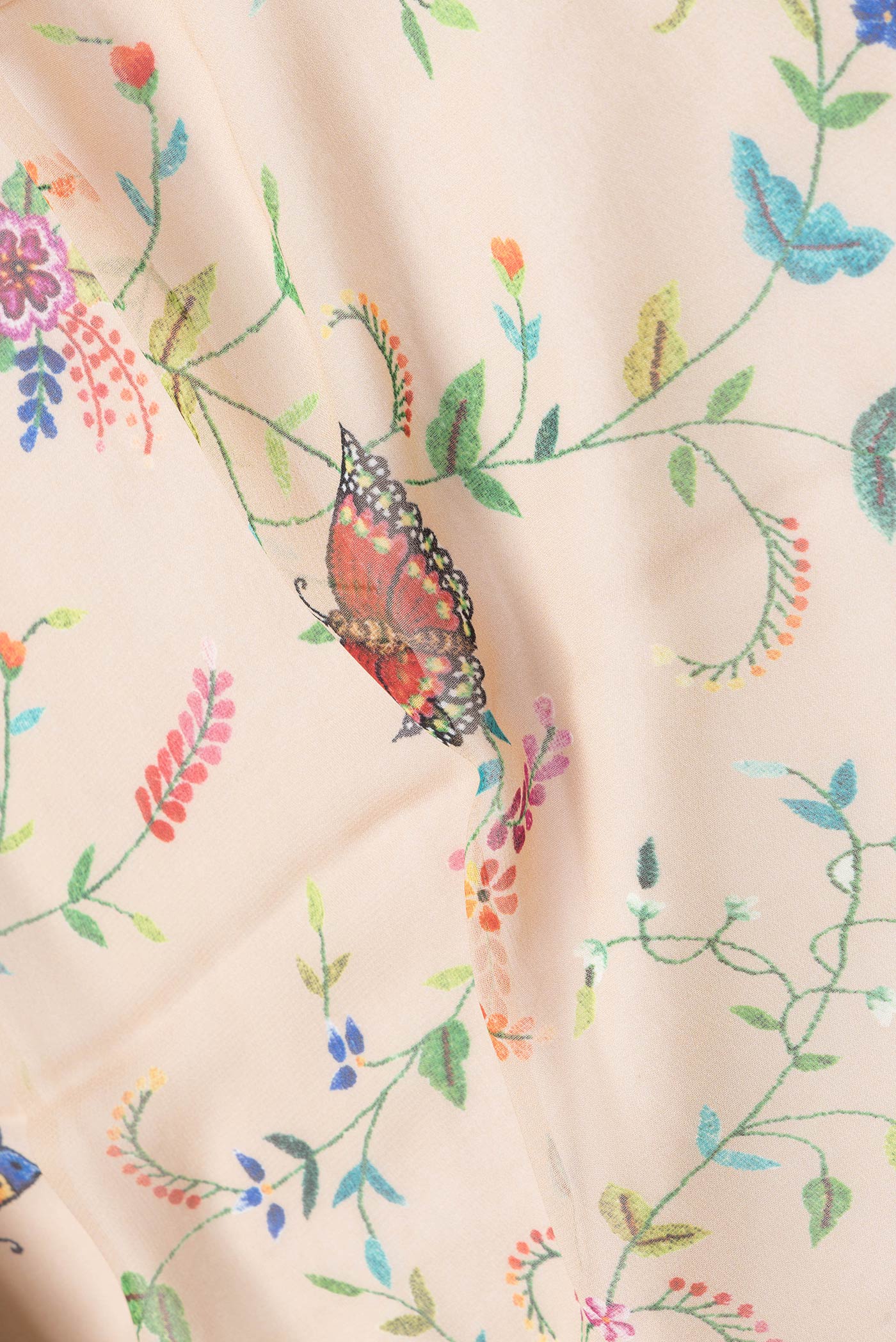 Close up of Beige Dual Tone Mysore Georgette Saree with Printed design on the body and Without Border.  displaying folds