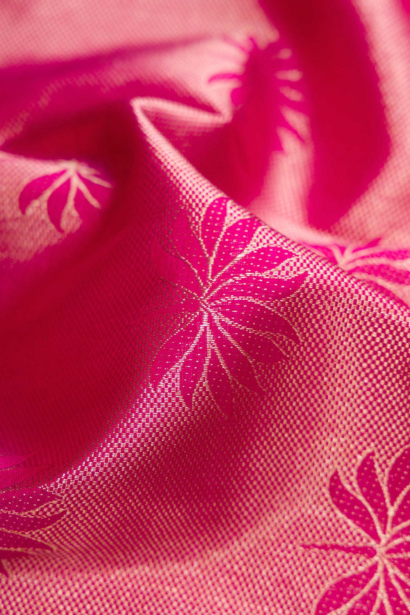 Close up of Pink Dual Tone Kanchipuram Silk Saree with Zari Brocade on the body and Zari Border.  displaying folds