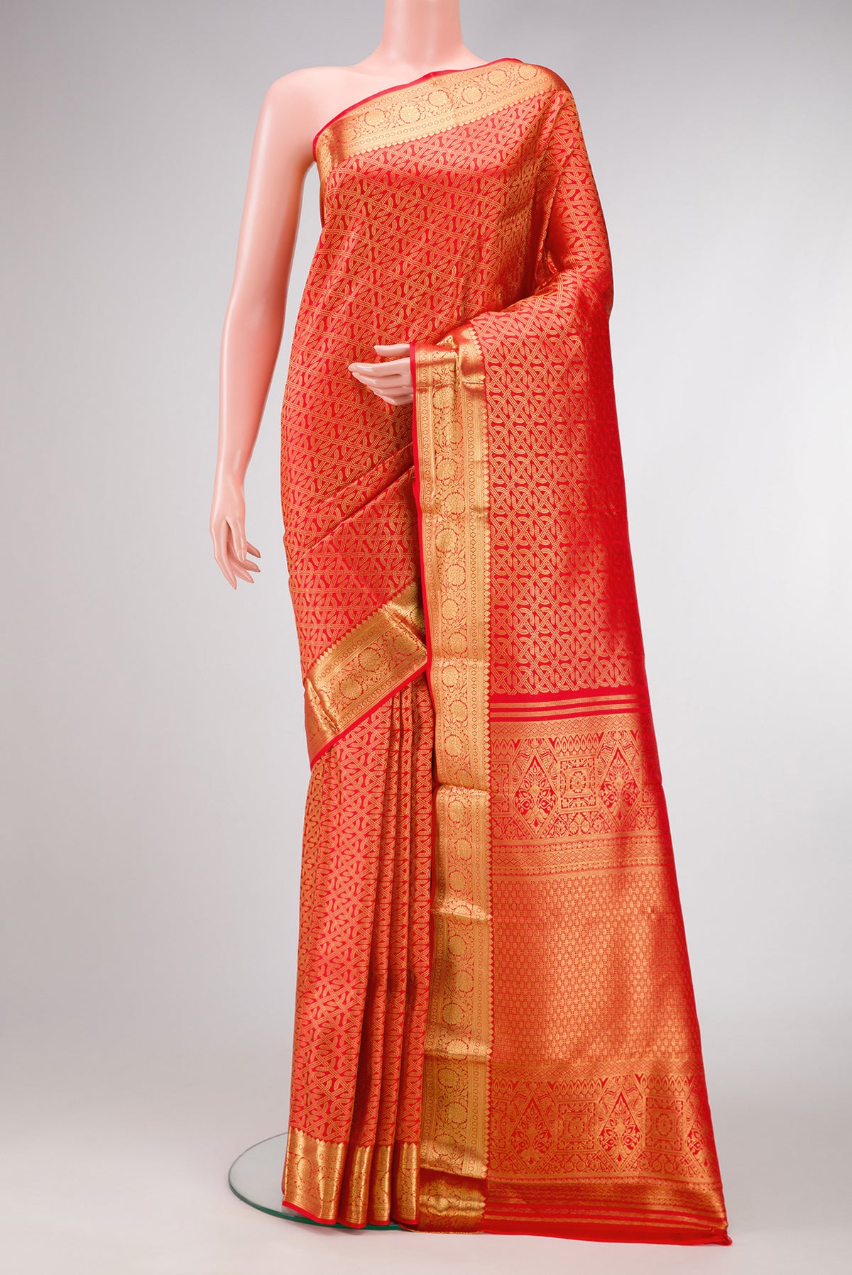 Red Dual Tone Kanjivaram Silk Saree with Zari Brocade on the body and Zari Border.  displayed on a mannequin