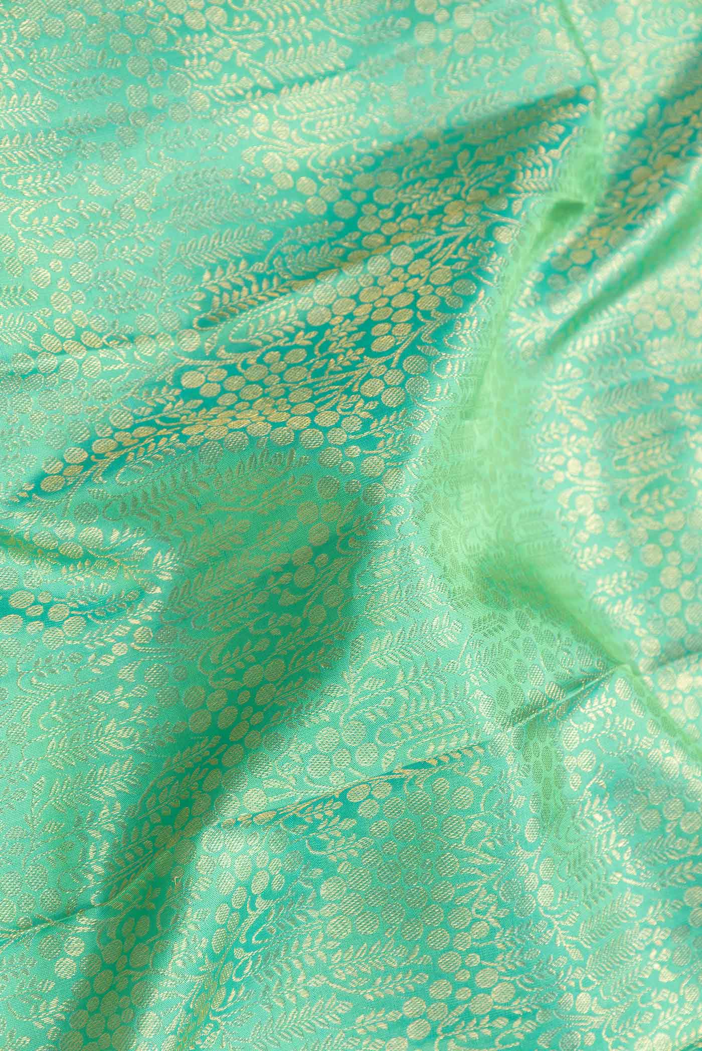 Close up of Sea Green Dual Tone Kanchipuram Silk Saree with Zari Brocade on the body and Zari Border displaying folds