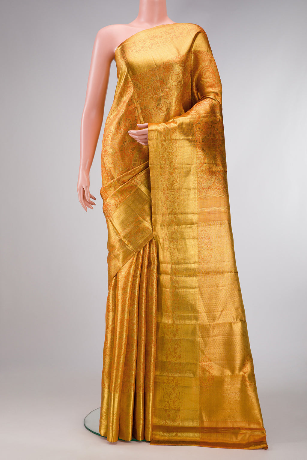 Orange Dual Tone Kanjivaram Tissue Silk Saree with Zari Brocade on the body and Zari Border.  displayed on a mannequin