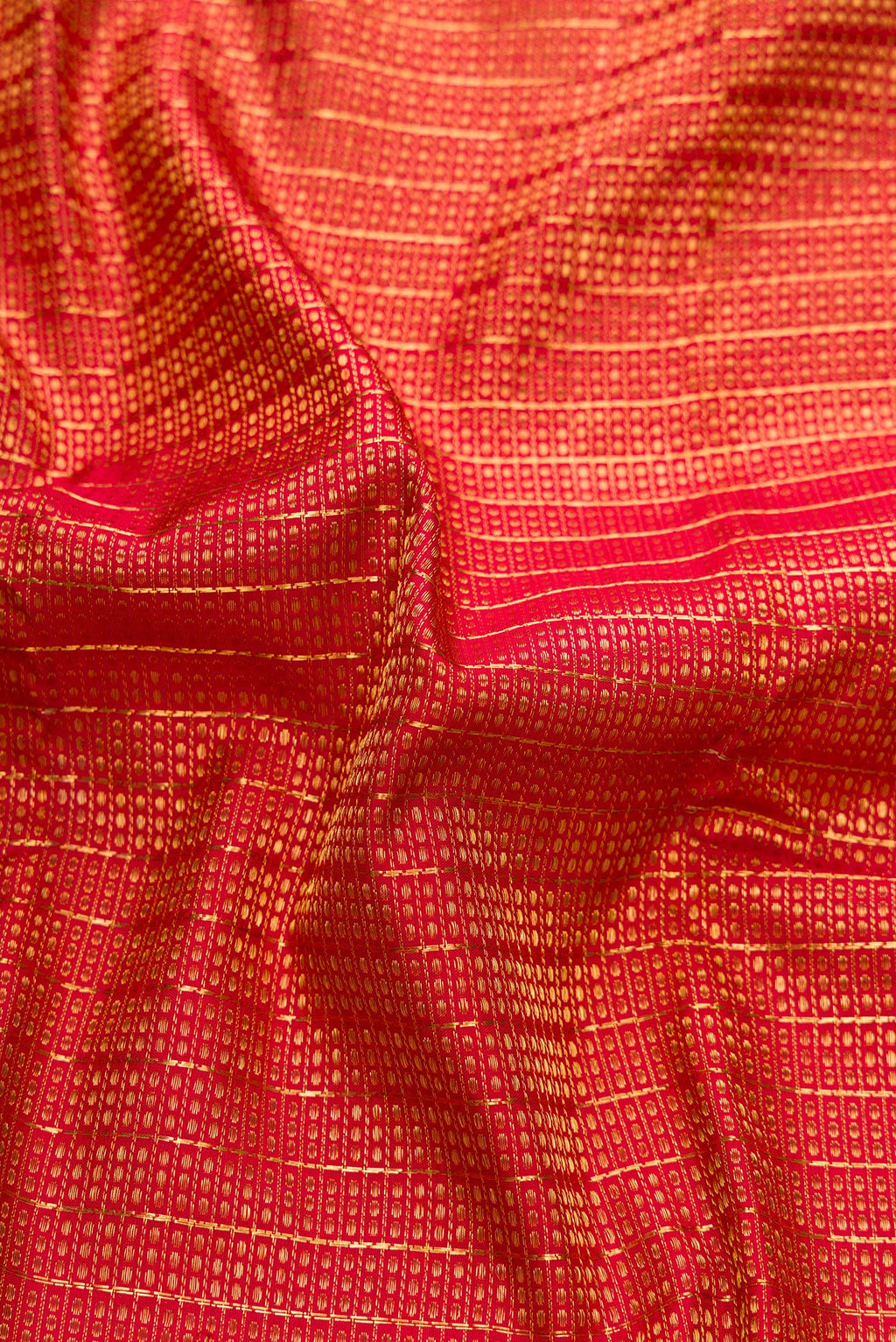 Close up of Maroon Dual Tone Kanchipuram Silk Saree with Zari Brocade on the body and Zari Border.  displaying folds