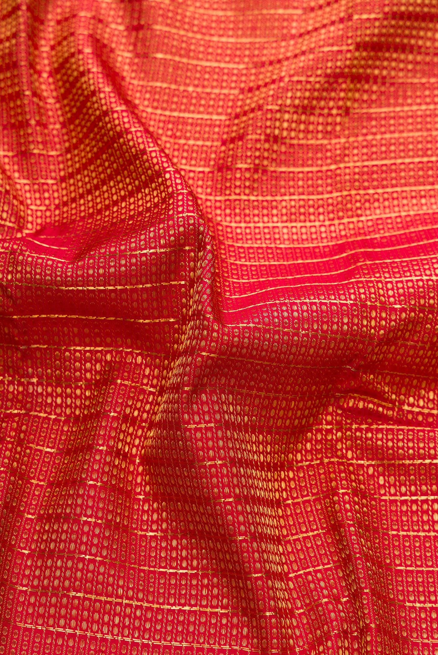 Close up of Maroon Dual Tone Kanchipuram Silk Saree with Zari Brocade on the body and Zari Border.  displaying folds