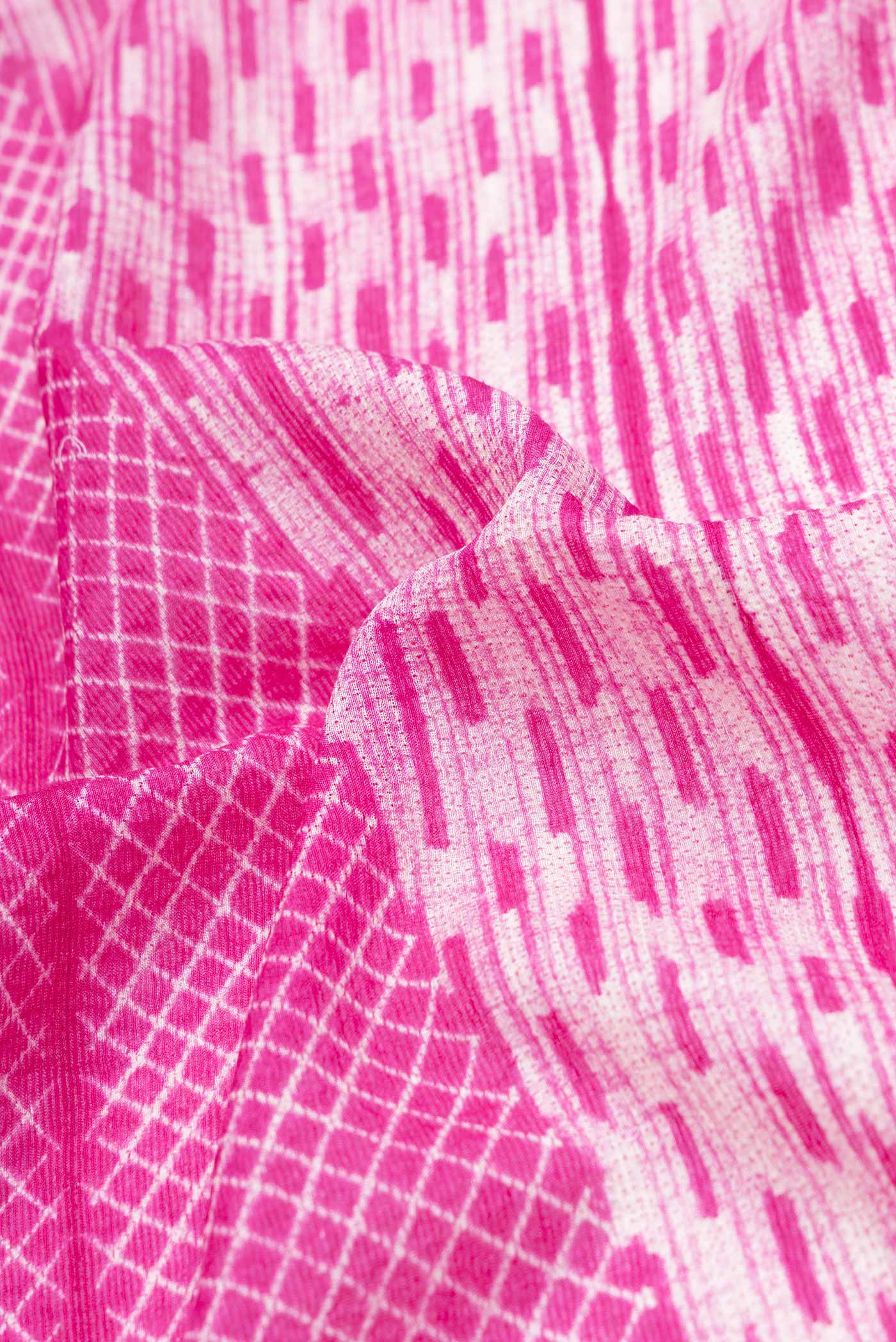 Close up of Pink Dual Tone Tussar Saree with Printed design on the body and Zari Border.  displaying folds