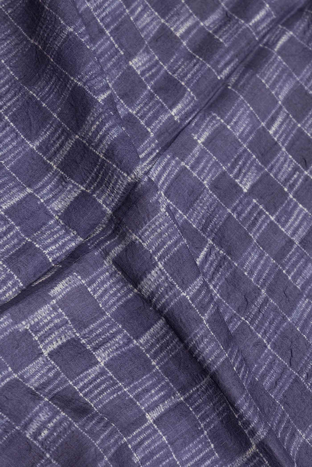 Close up of Navy Blue Dual Tone Tussar Saree with Checked design on the body and Zari Border.  displaying folds