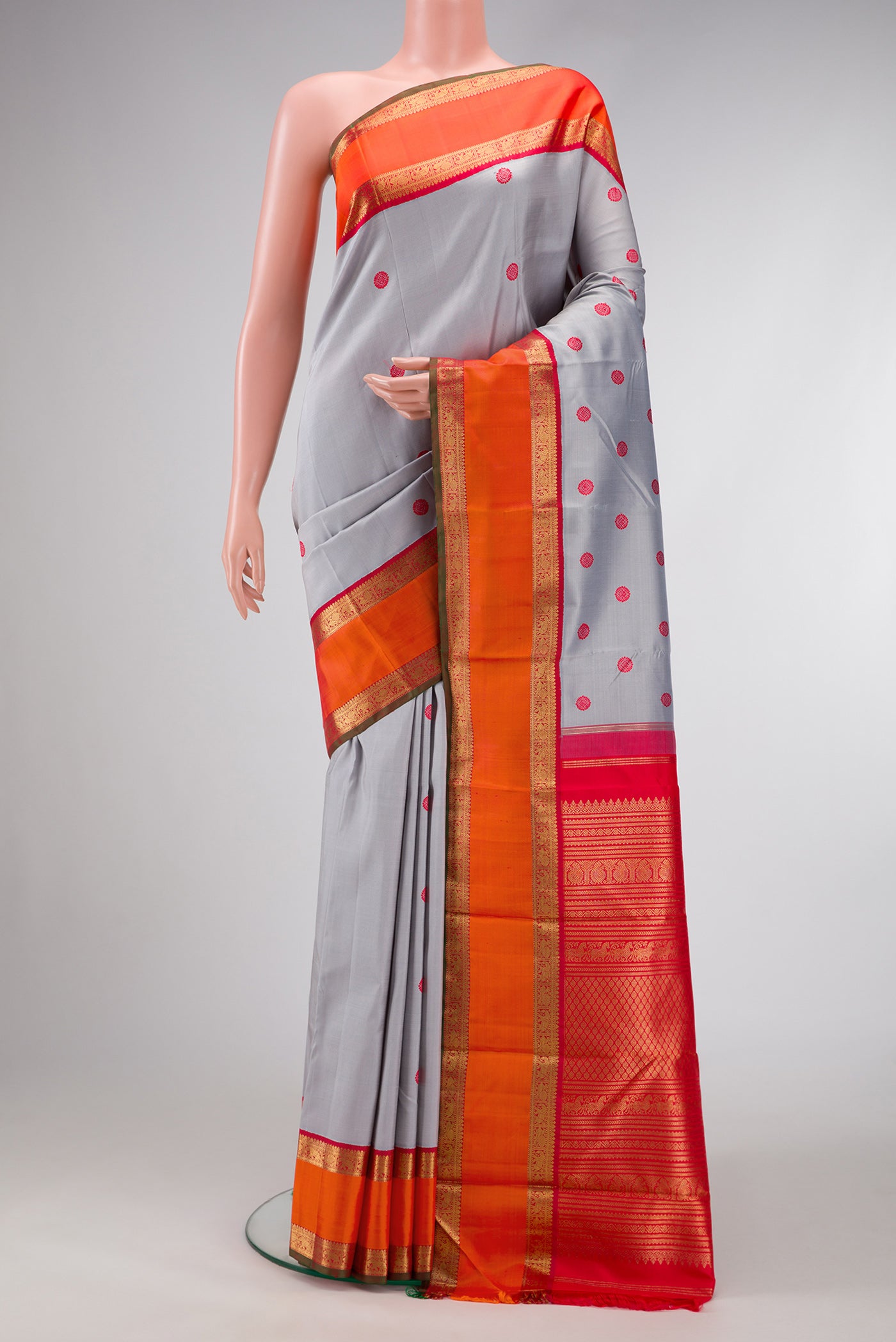 Pure Silk Pure Zari Grey Dual Tone Kanchipuram Saree with Thread Butta on the body and Zari Border.  displayed on a mannequin