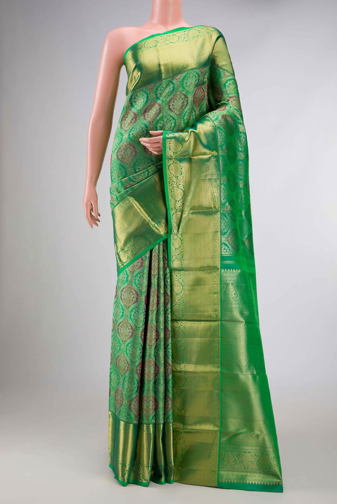 Green Dual Tone Kanchipuram Saree with Zari Brocade on the body and Zari Border displayed on a mannequin