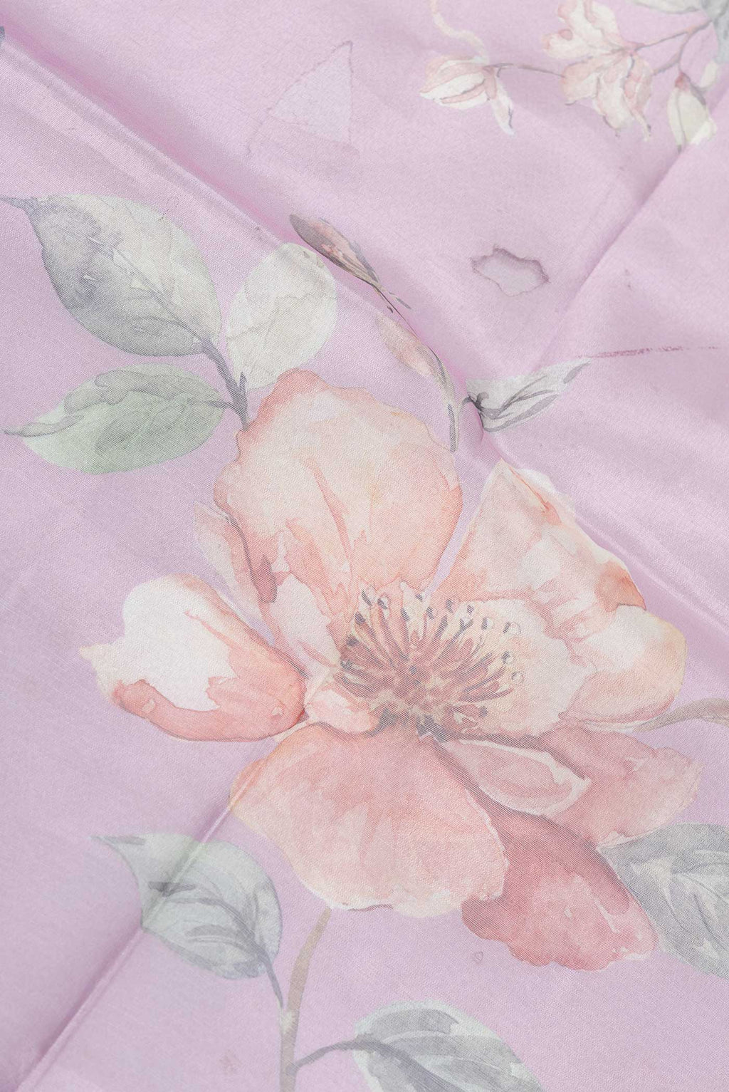 Close up of Lavender Dual Tone Tissue Silk SareePrinted design on the body and Embroidery Border displaying folds