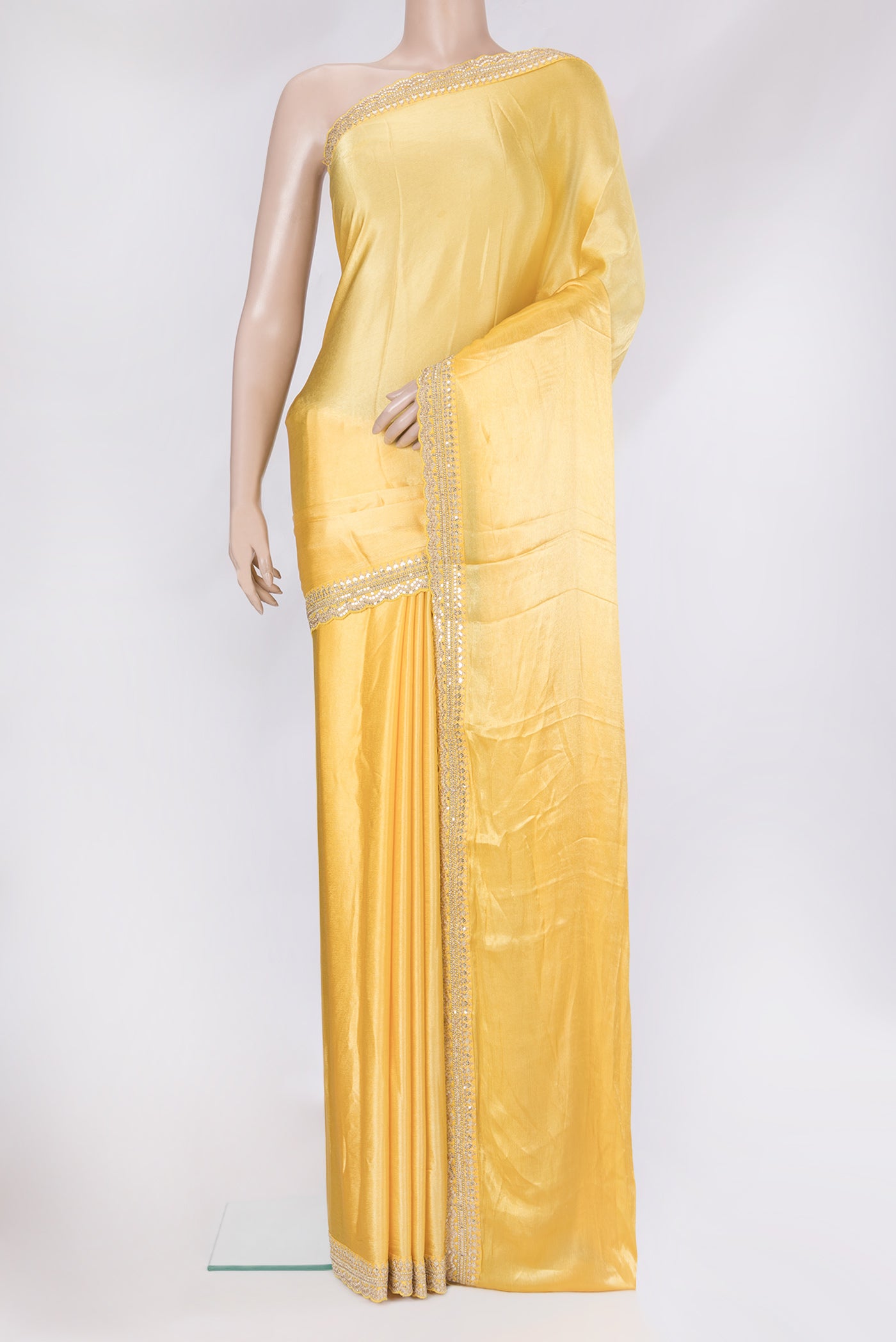 Yellow Satin Crepe Saree with Plain Body and Embroidery Border.  displayed on a mannequin