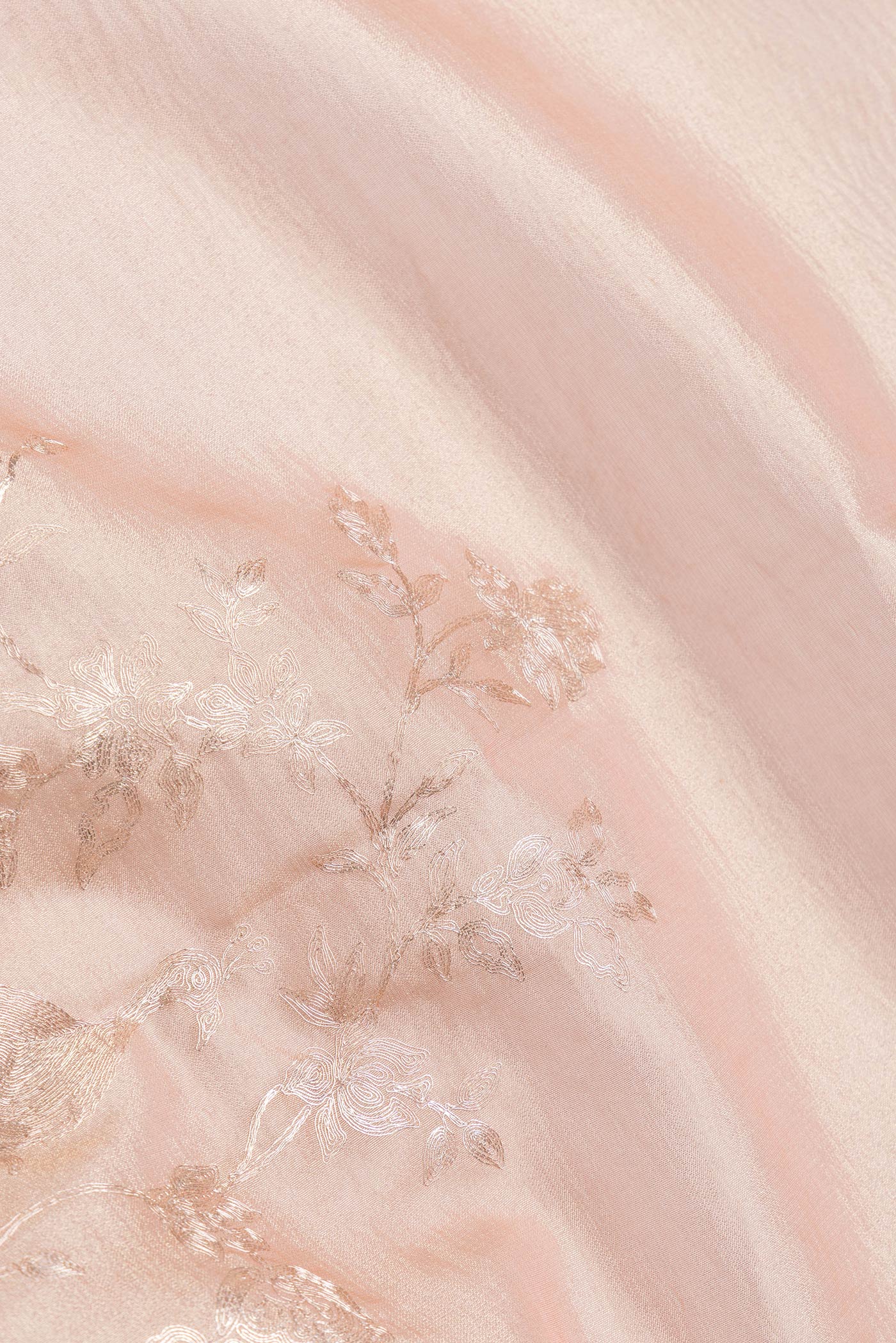 Close up of Rose Gold Dual Tone Organza Silk Saree with Zari Brocade on the body and Plain Border.  displaying folds