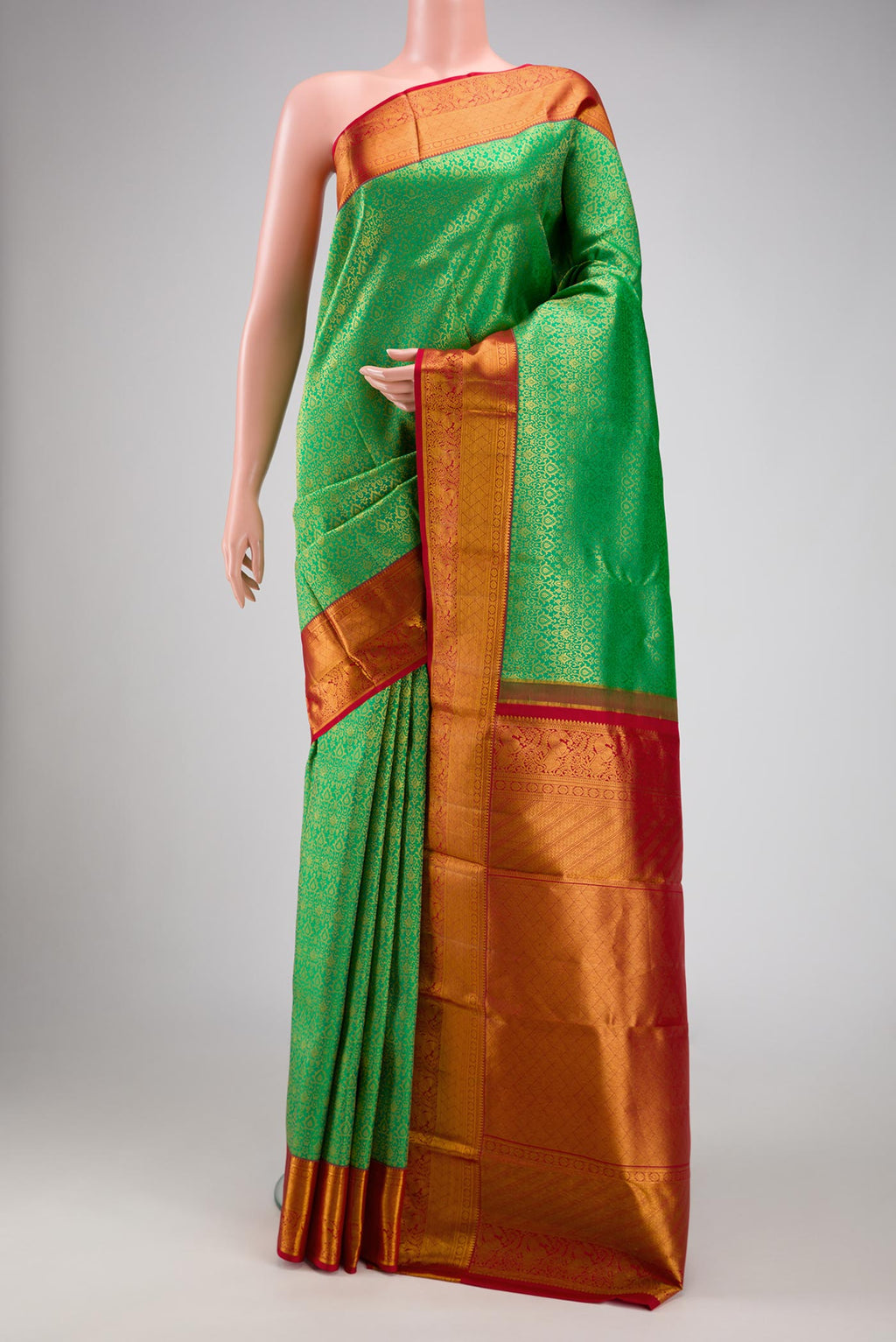 Green Dual Tone Kanchipuram Silk Saree with Zari Brocade on the body and Zari Border.  displayed on a mannequin