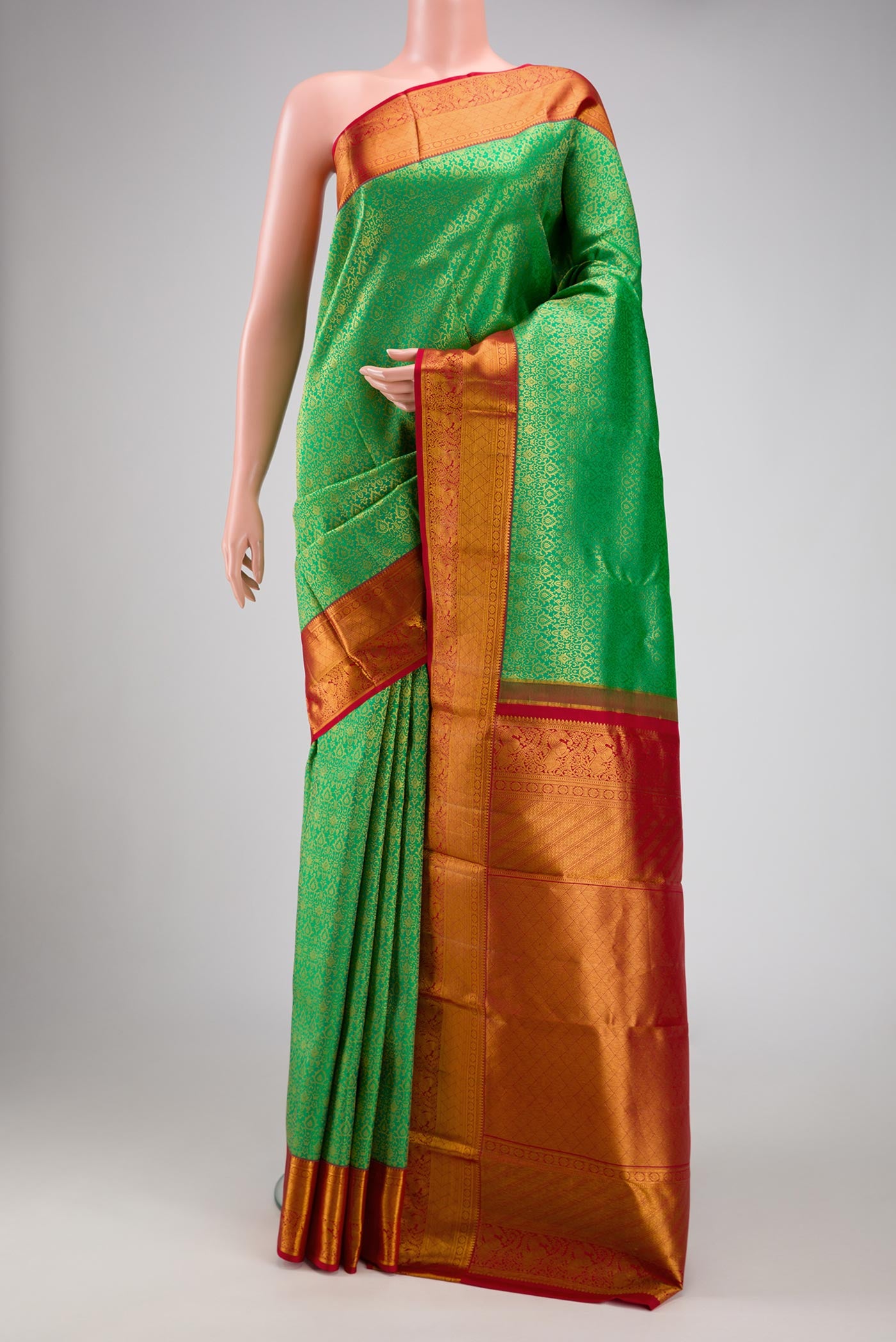 Green Dual Tone Kanchipuram Silk Saree with Zari Brocade on the body and Zari Border.  displayed on a mannequin