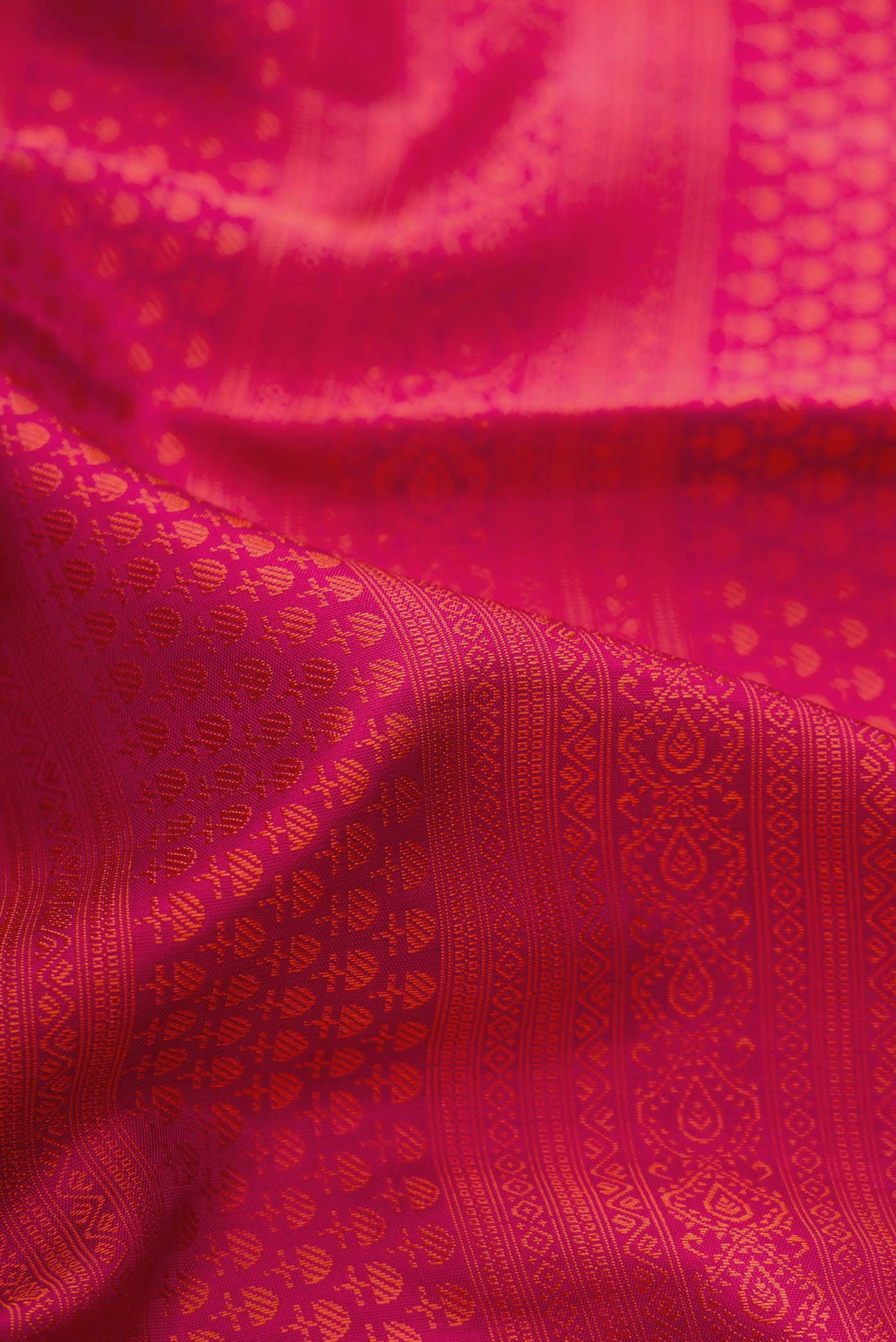 Close up of Pure Silk Pure Zari Maroon Dual Tone Kanchipuram Saree with Jacquard design on the body and Zari Border.  displaying folds