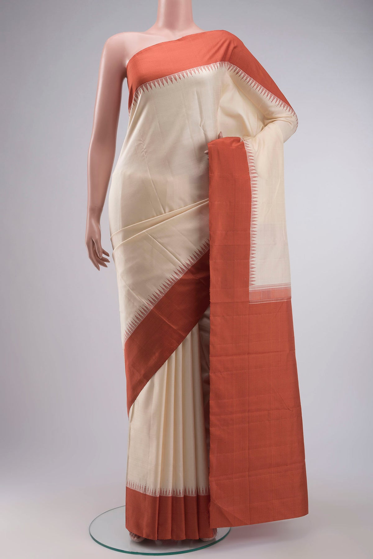 Cream Kanchipuram Silk Saree with Plain Body and Temple Border displayed on a mannequin
