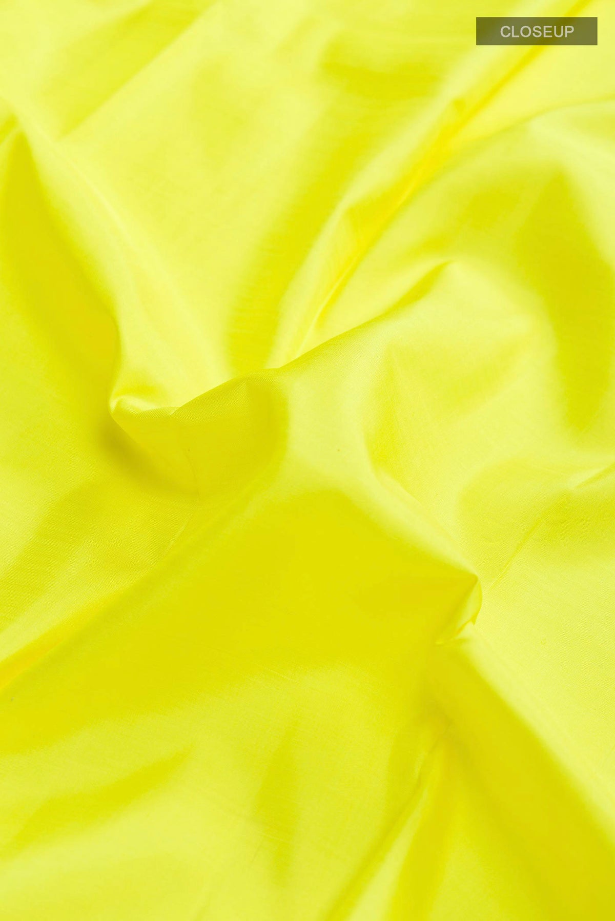 Close up of Yellow Kanchipuram Silk Saree with Plain Body and Zari Border displaying folds