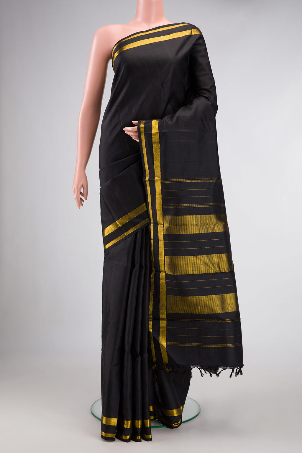 Black Dual Tone Kanjivaram Silk Saree with Plain Body and Zari Border.  displayed on a mannequin