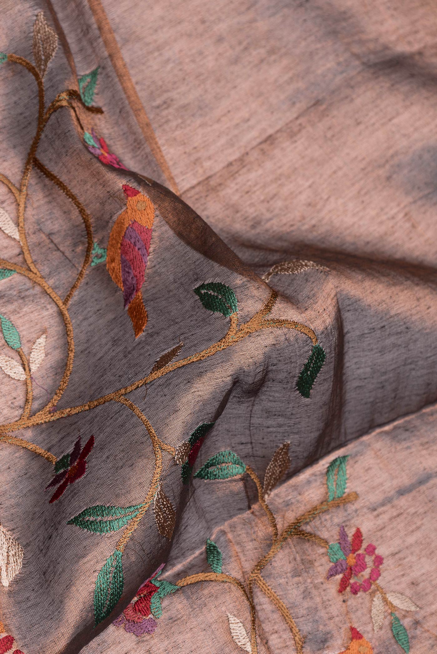 Close up of Maroon Dual Tone Organza Silk Saree with Embroidery on the body and Zari Border.  displaying folds