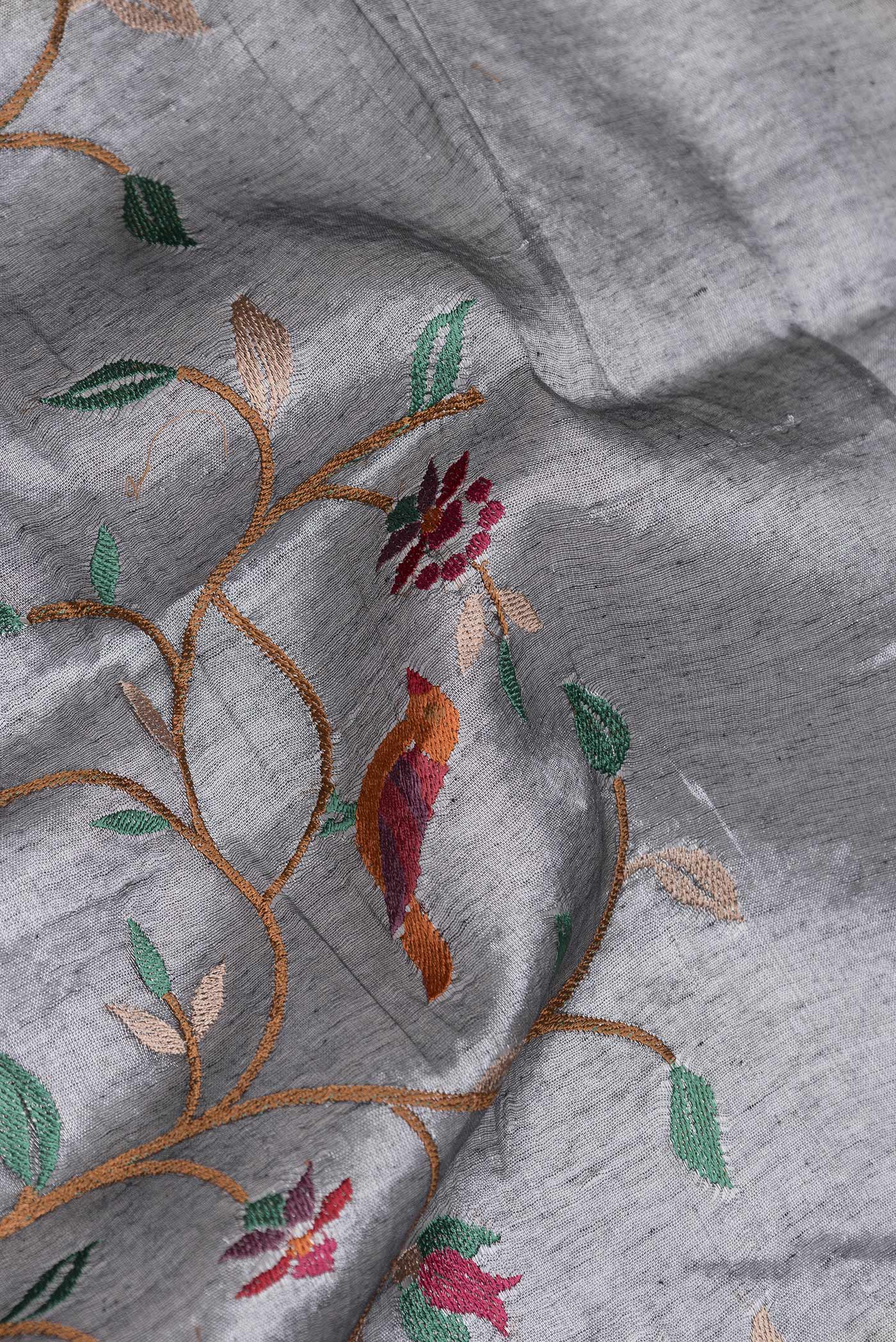 Close up of Grey Dual Tone Organza Silk Saree with Embroidery on the body and Zari Border.  displaying folds