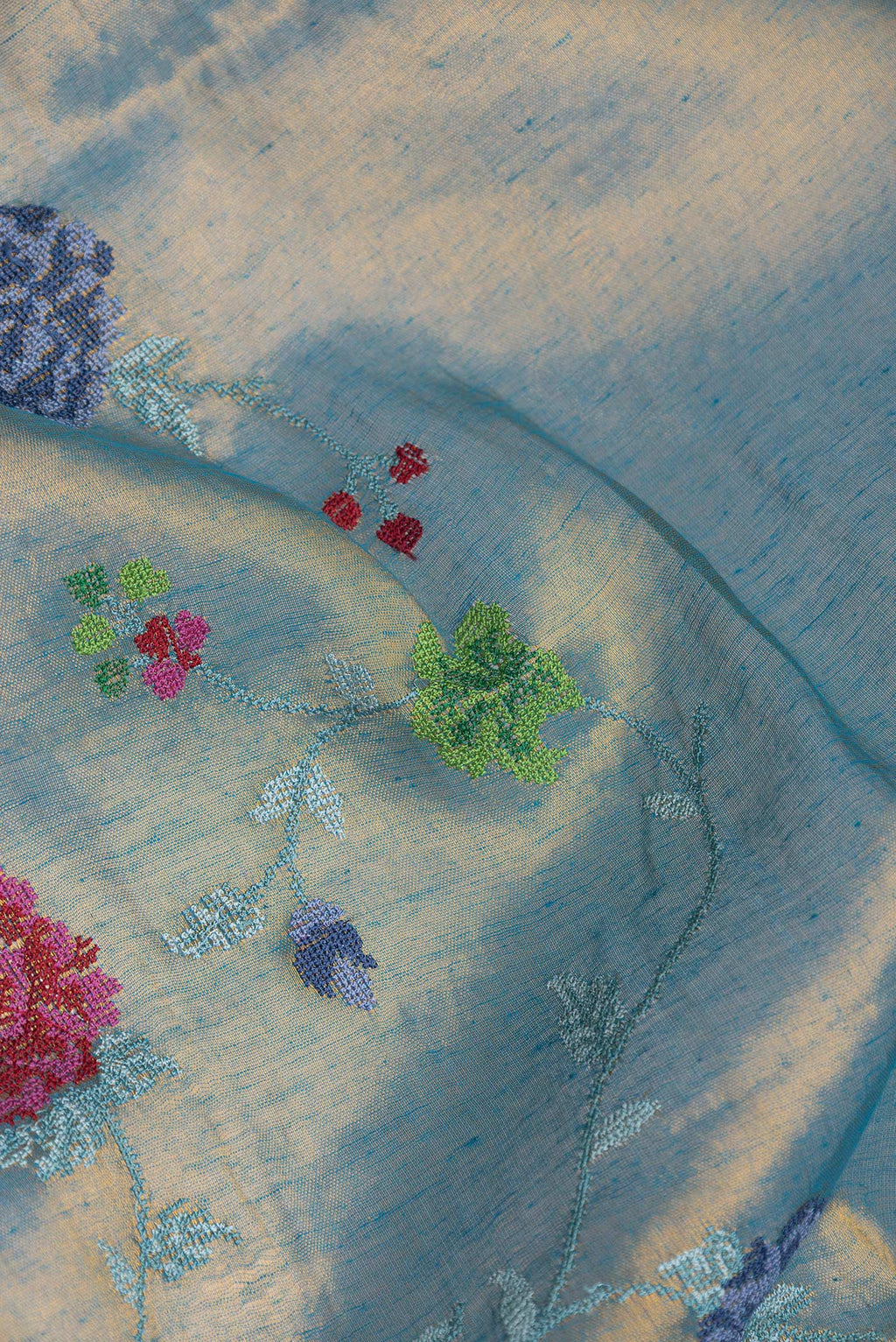 Close up of Pista Green Dual Tone Organza Silk Saree with Embroidery on the body and Zari Border.  displaying folds