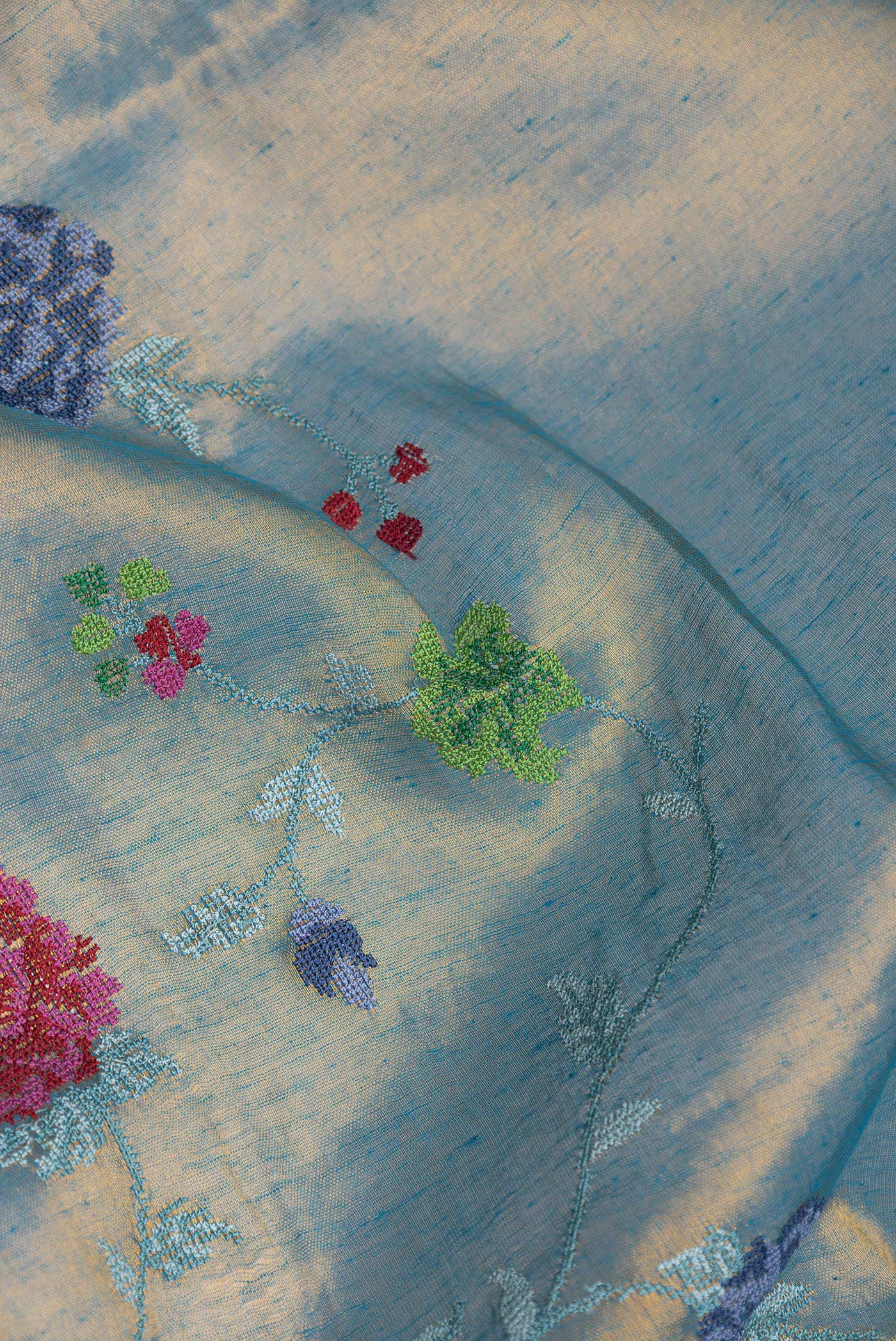 Close up of Pista Green Dual Tone Organza Silk Saree with Embroidery on the body and Zari Border.  displaying folds