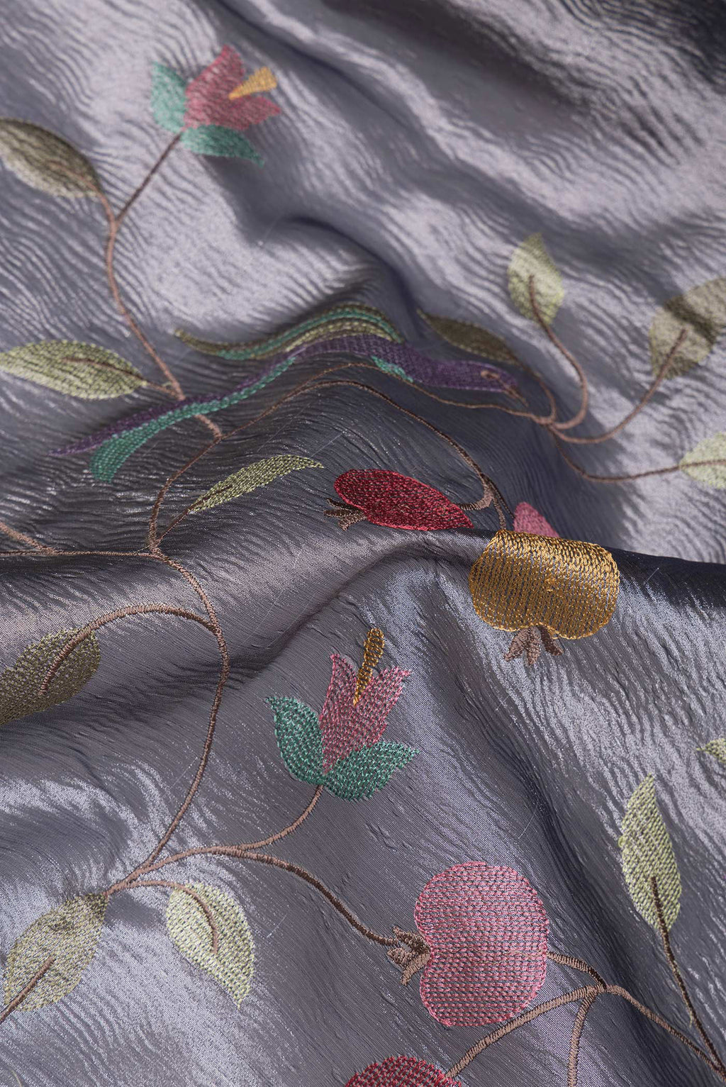 Close up of Grey Dual Tone Organza Silk Saree with Embroidery on the body and Plain Border.  displaying folds