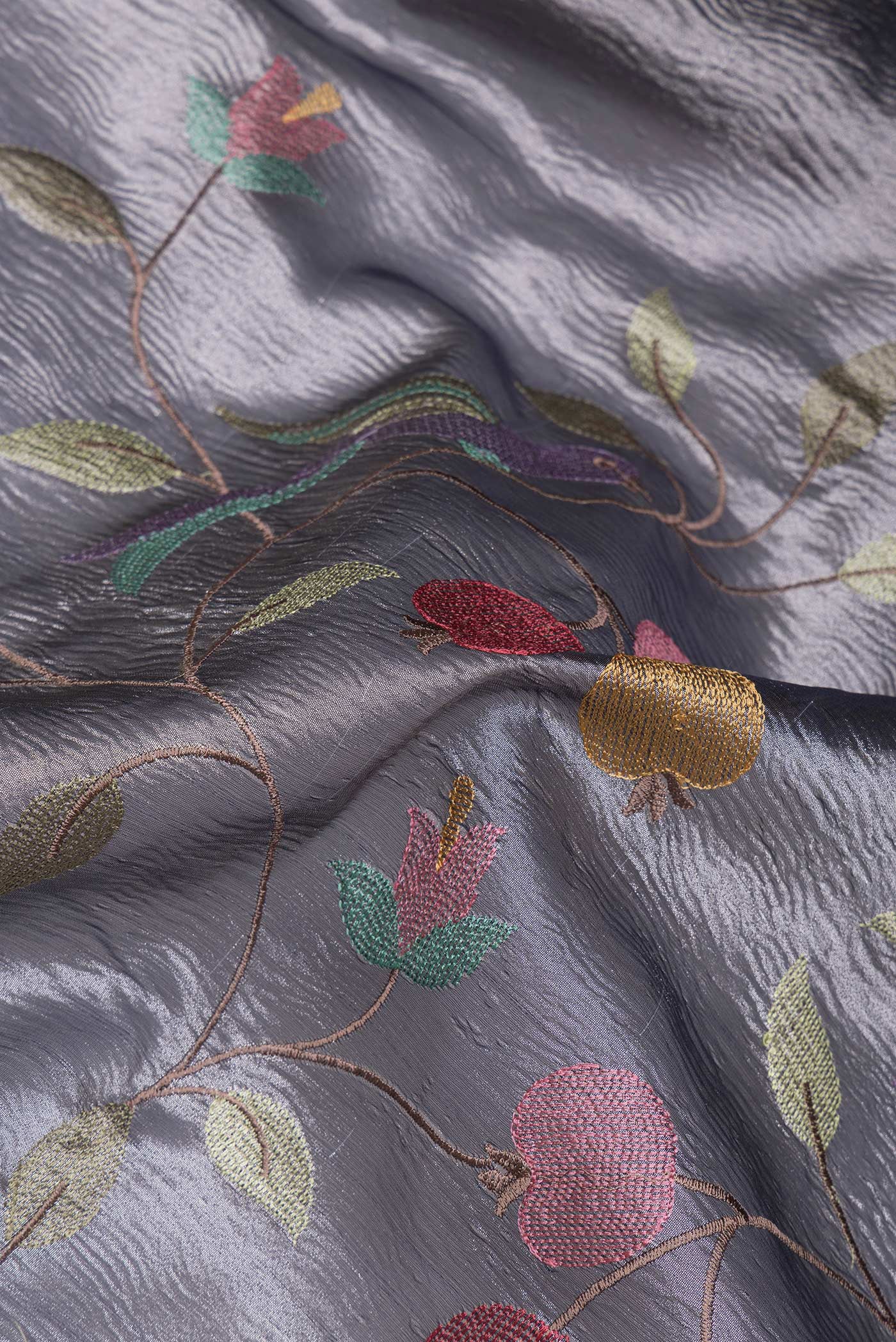 Close up of Grey Dual Tone Organza Silk Saree with Embroidery on the body and Plain Border.  displaying folds