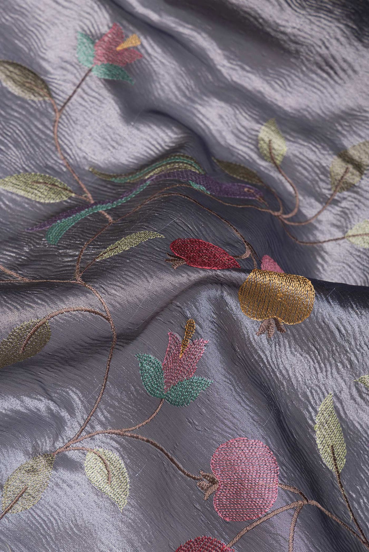 Close up of Grey Dual Tone Organza Silk Saree with Embroidery on the body and Plain Border.  displaying folds