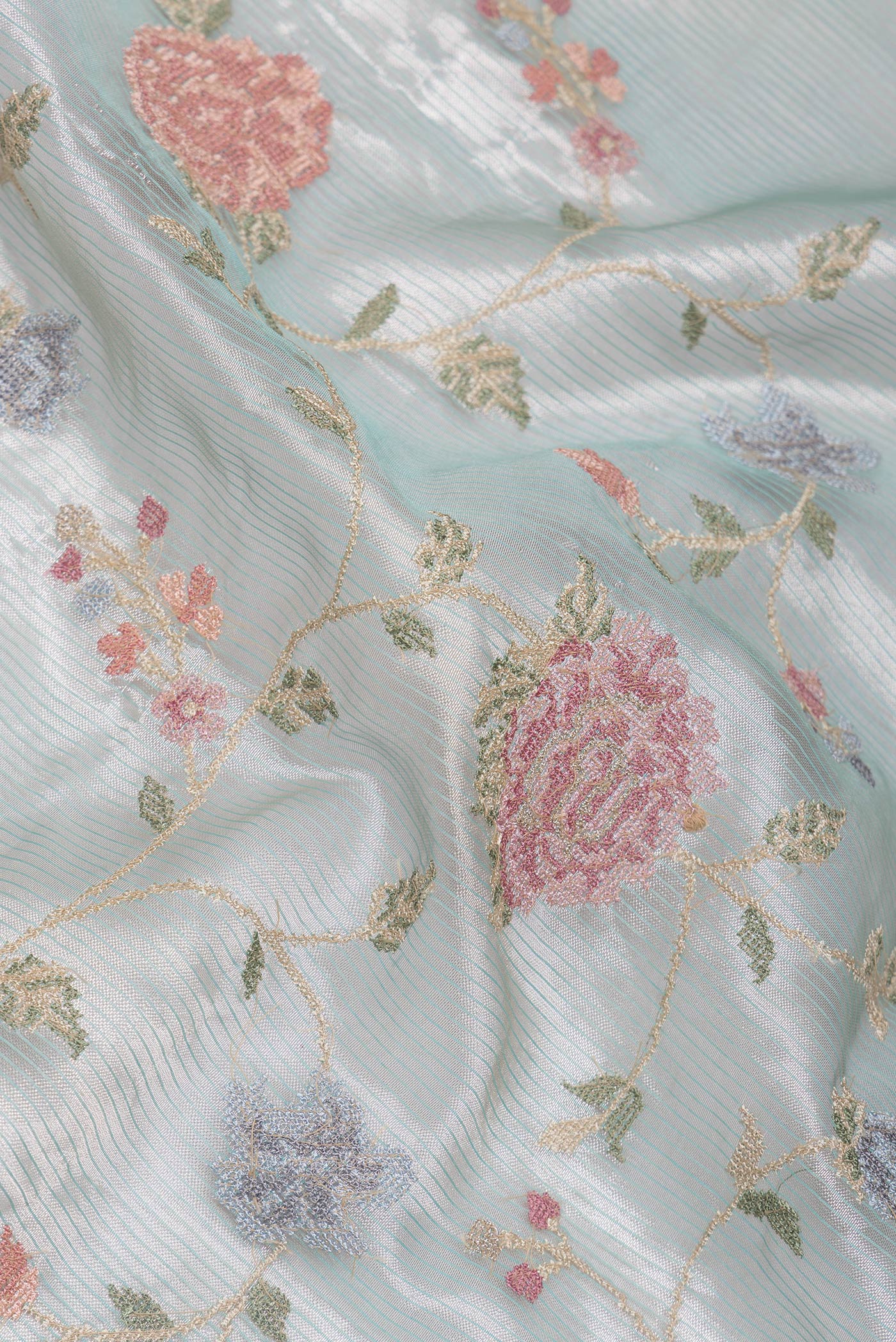 Close up of Sea Green Dual Tone Organza Silk Saree with Embroidery on the body and Zari And Thread Border.  displaying folds