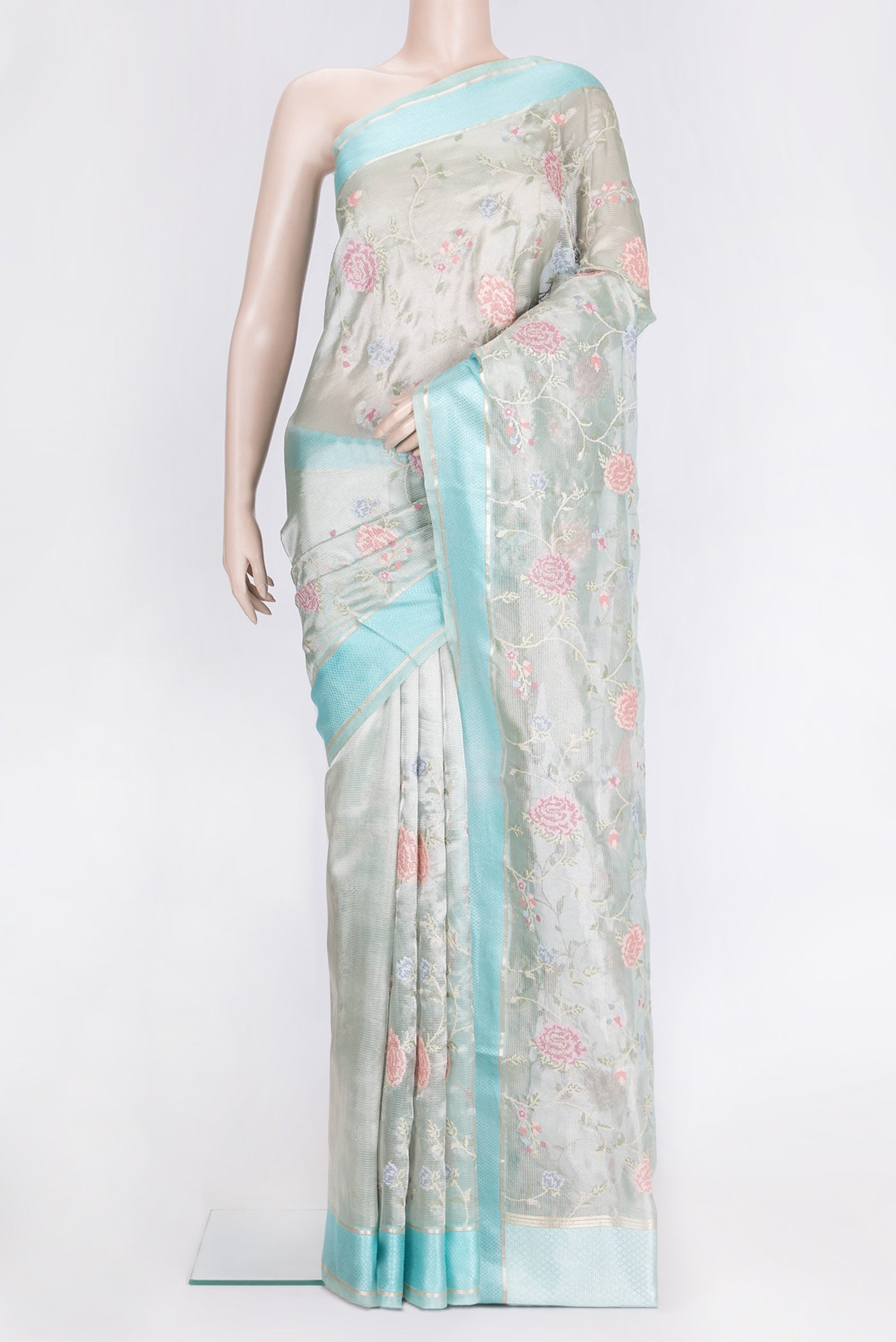 Sea Green Dual Tone Organza Silk Saree with Embroidery on the body and Zari And Thread Border.  displayed on a mannequin