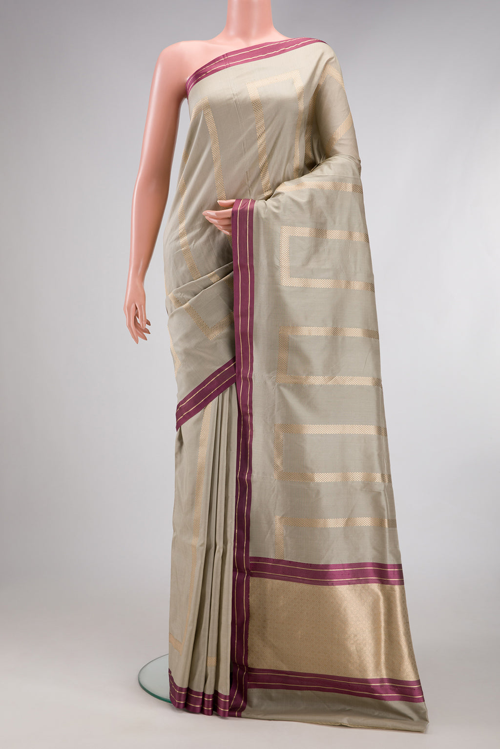 Beige Banarasi Silk Saree with Stripes on the body and Zari Border.  displayed on a mannequin
