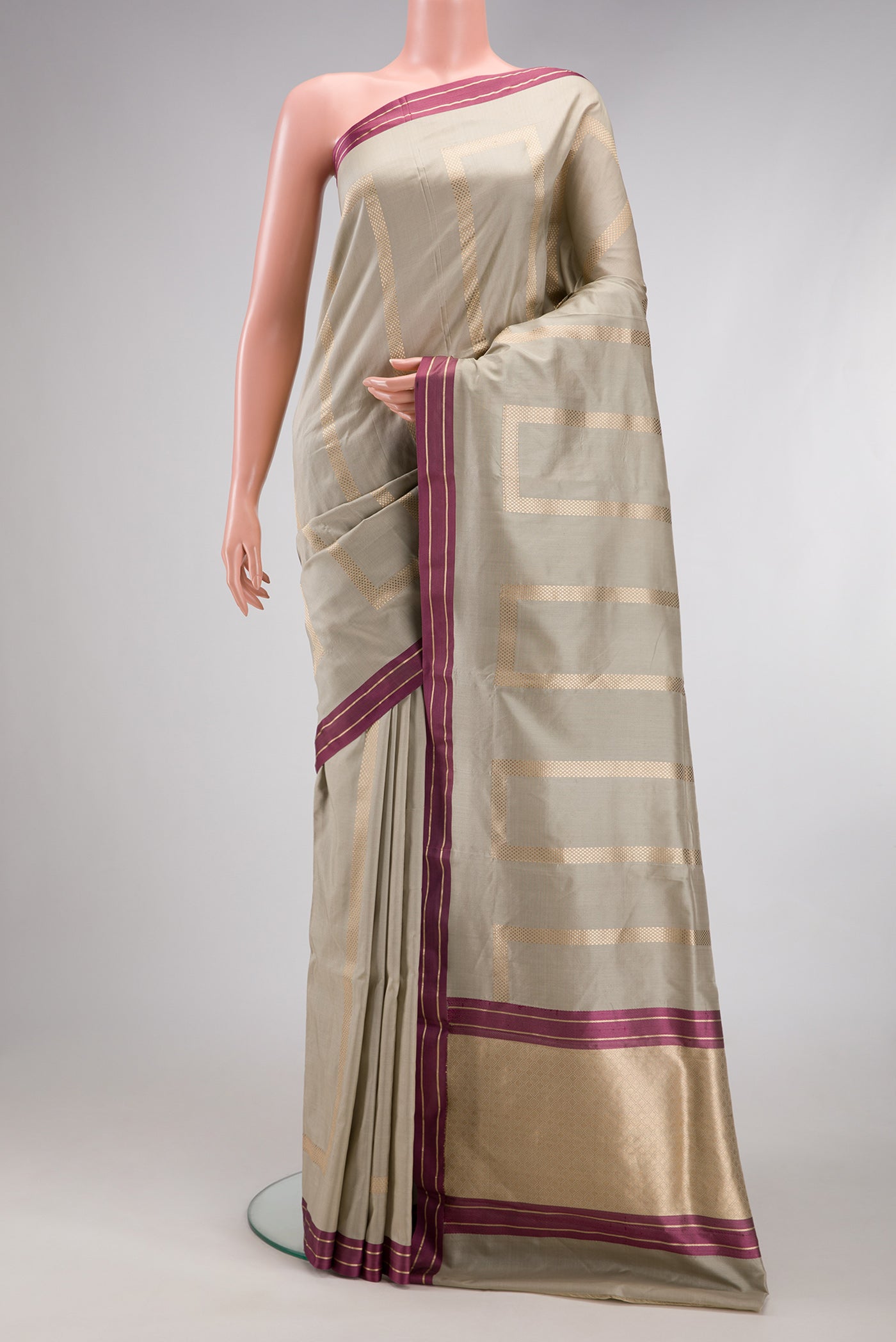 Beige Banarasi Silk Saree with Stripes on the body and Zari Border.  displayed on a mannequin