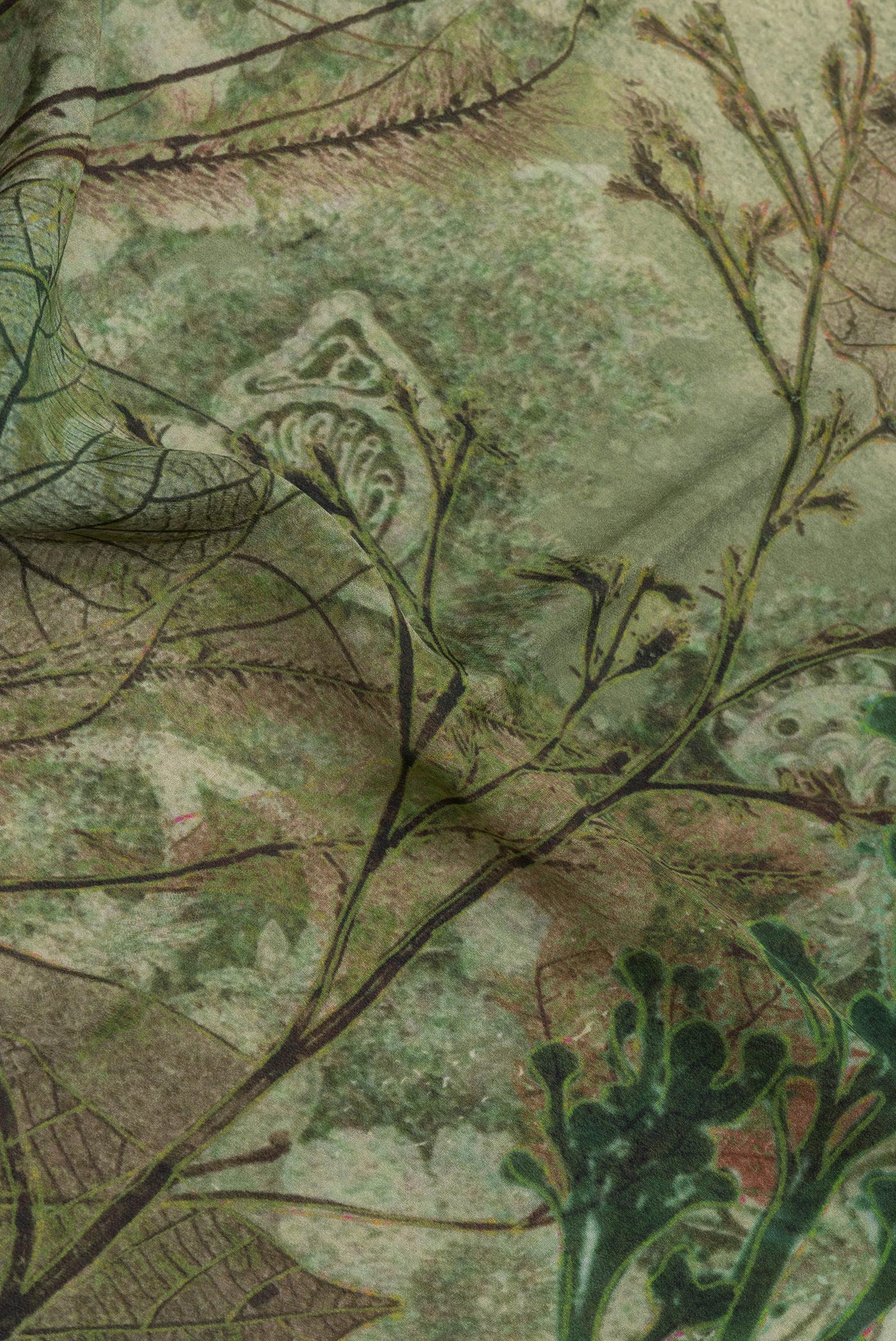 Close up of Mehandi Green Crepe Saree with Printed design on the body and Zari Border.  displaying folds