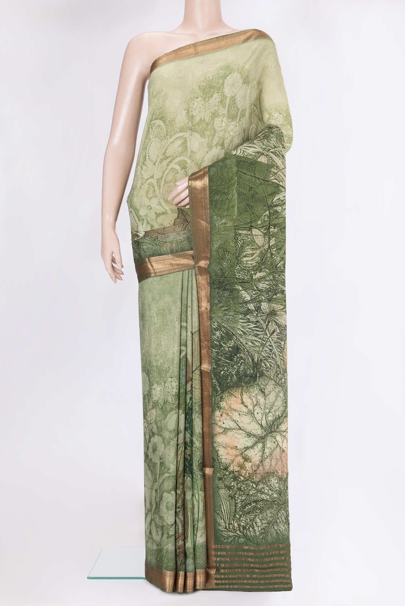 Mehandi Green Crepe Saree with Printed design on the body and Zari Border.  displayed on a mannequin